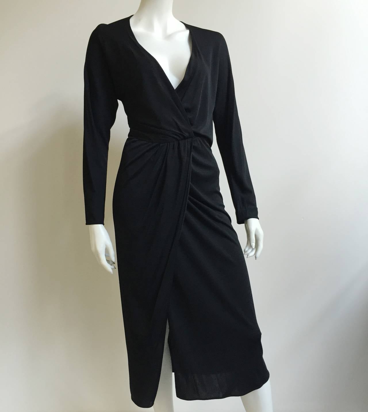 Halston 1970s black jersey wrap disco dress size 4 ( please see & use measurements). There are two hooks and one snap button that keeps wrap dress in place. The plunging neckline is very loose & very revealing just as Halston designed it. This is a
