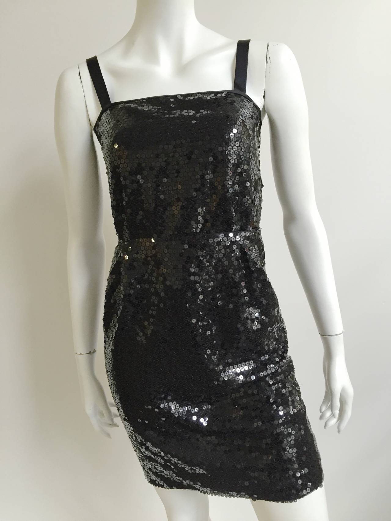 Laura Biagiotti 1980s black sequin cocktail dress size original size Italian 42 but fits like a modern USA size 4 ( Please see & use measurements to measure your body). Satin straps and zipper at back of dress. Dress is lined.
Empire waist