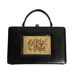 Prestige 60s brass relief black leather handbag.