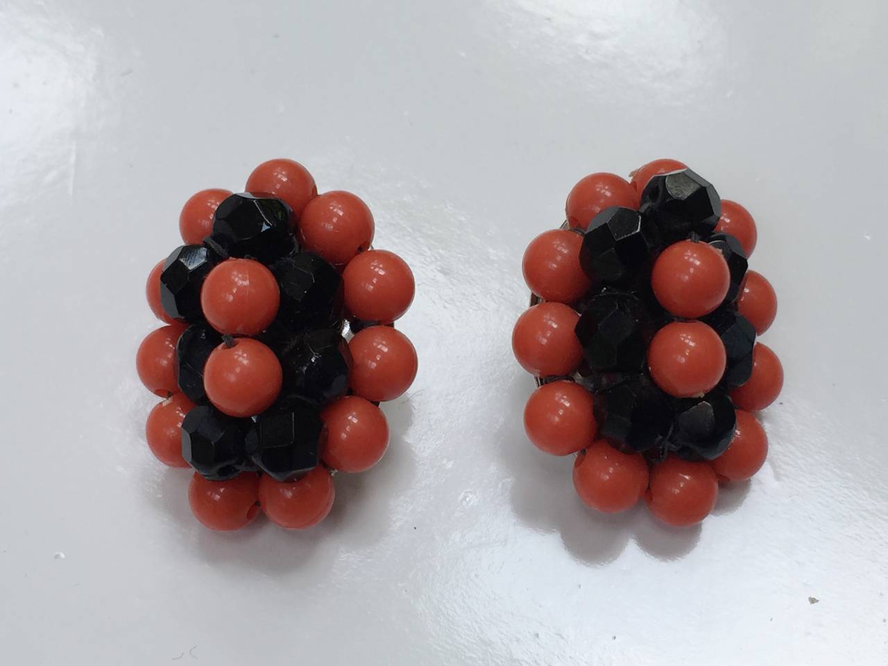 Elsa Schiaparelli 1960s coral & black beads clip earrings.
1