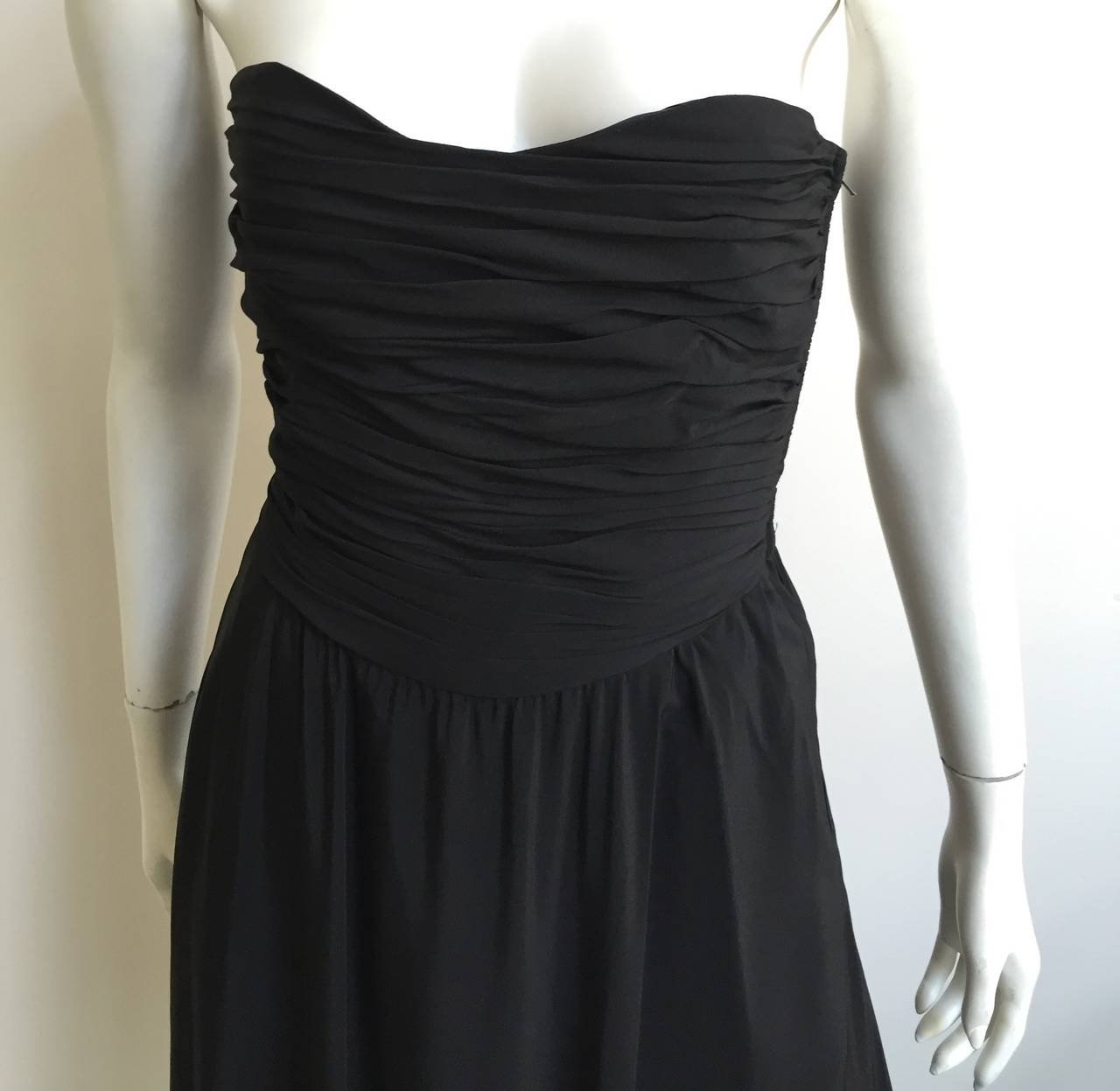 Albert Nipon for Neiman Marcus 1980s black silk strapless dress with pockets original size 8 but fits like a modern 4.  Please see & use measurements to measure to make sure this dress will fit you to perfection.
This strapless evening dress with