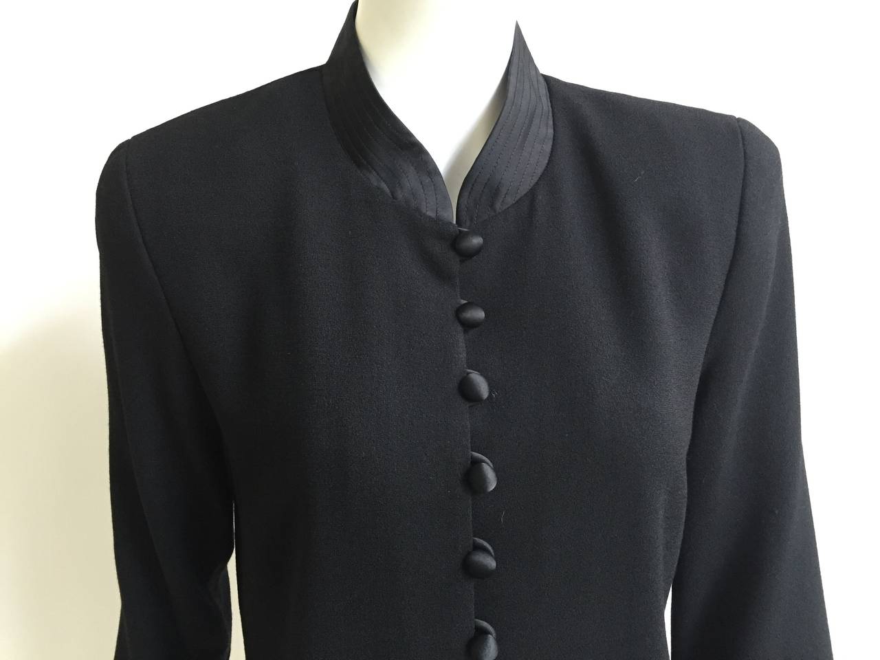 Scaasi 1980s long black wool jacket with quilted sleeve cuffs and collar is a size 10. Jacket is lined and made in the USA. This long black jacket would work perfectly with any of your vintage tuxedo pants for that well polished look.
Measurements