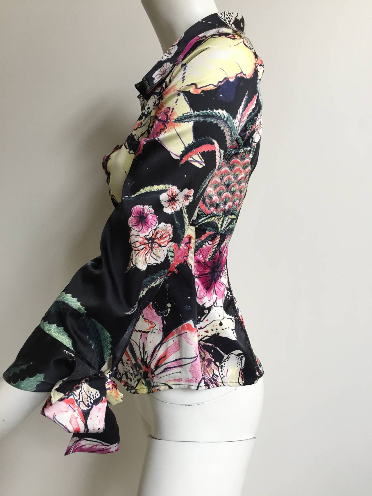 Just Cavalli by Roberto Cavalli floral pattern stretch fabric blouse with bow tie sleeve cuffs is a small size. The mannequin is a true size 4 and it fits but snuggly. 
Measurements are:
32" bust
27" waist
20" sleeve