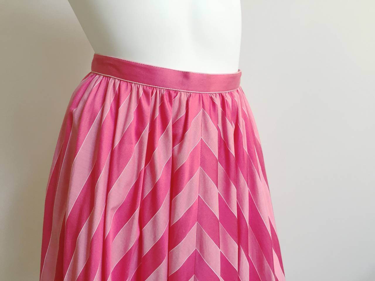 Adele Simpson 1980s for Saks Fifth Avenue pink striped cotton flare skirt with pockets is an original size 10 but fits like a modern USA size 6 ( Please see & use measurements to make sure this skirt will fit your body perfectly).
Buttons on side