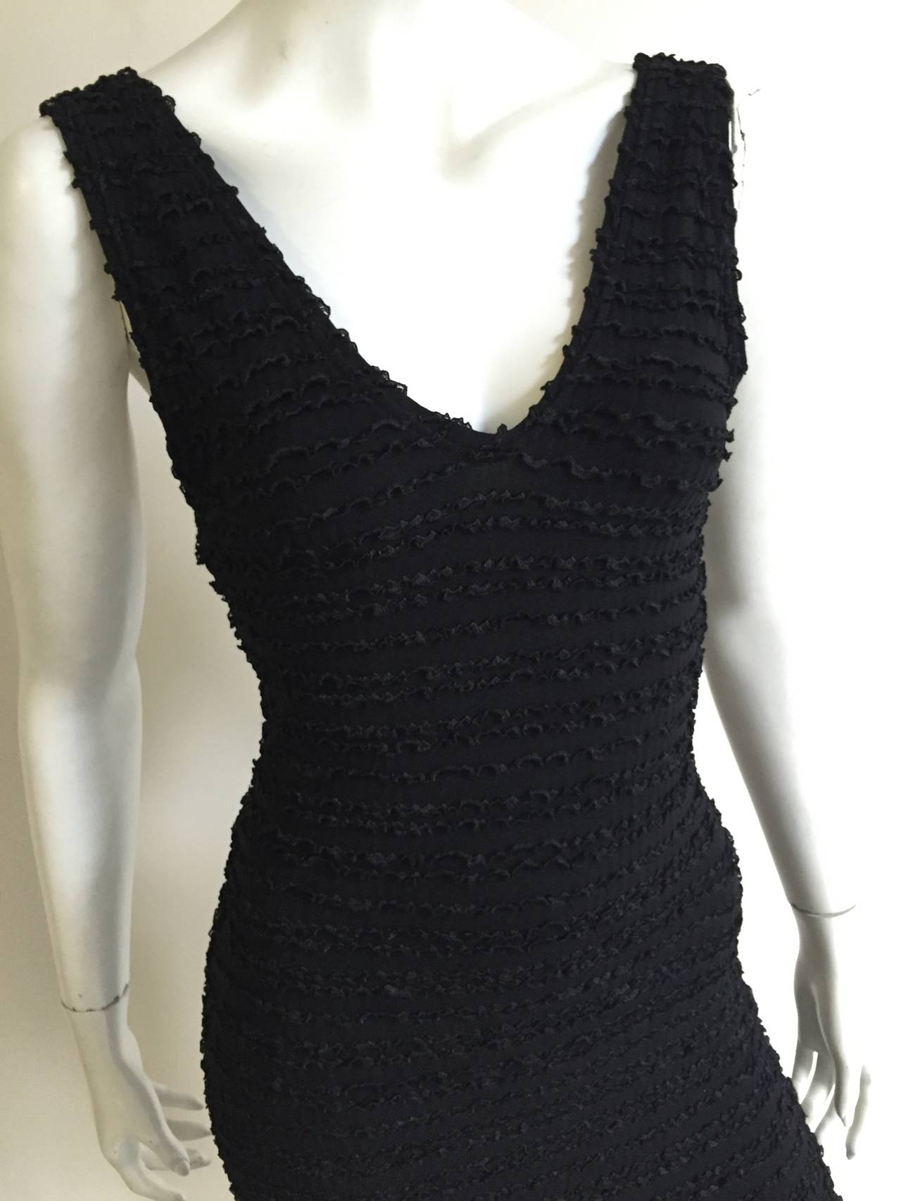 Patrick Kelly Paris 1986 black stretch Flamenco style dress is an original size Medium but fits like a modern day USA size 4 ( Please see & use measurements to properly measure your lovely body). The swoop bottom cut of this dress is timeless. This