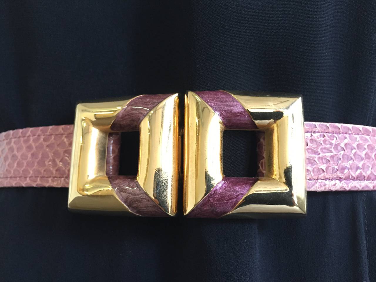 Alexis Kirk 1980s mauve snake skin strap with square brass buckle adjustable belt. There are two sliders on each side that adjust to size. There is an extra black snake skin belt that comes with this so you can easily change out for different look.