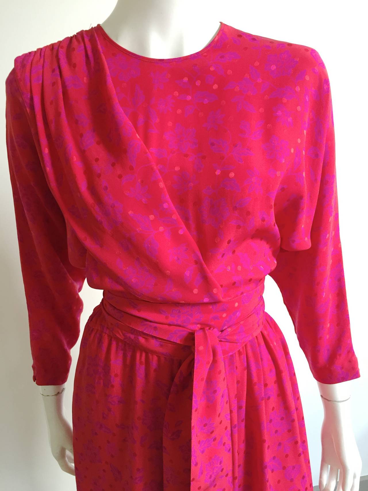 Guy Laroche 1970s silk dress with dolman sleeves and wrap skirt bottom is a French size 40 or a USA size 10.  Elastic waistband with long silk sash for waist. Silk fabric covered buttons on back of neckline and sleeves. Pockets on this dress.