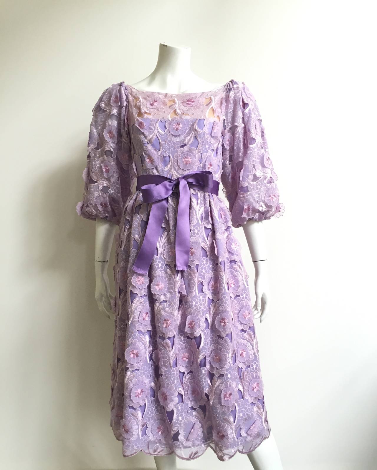 Richilene 1980s silk organza dress fits a size 4.   Please see & use measurements to make sure this will fit your to perfection. Bell shape sleeves. Dress has two interior layers, one layer is lavender silk organza and the interior layer is cotton.