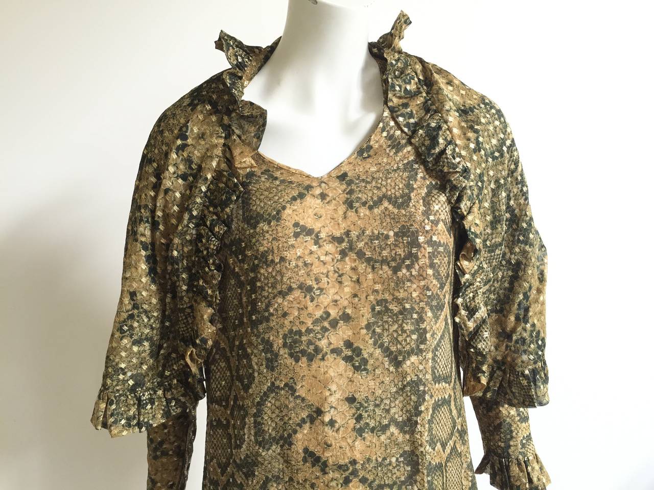 Bill Blass 1970s silk python print dress with shawl will fit a USA size 12.  Please see & use measurements so that you properly measure that lovely body. Zipper sleeves. Dress is silk lined. Ruffled edges with first class style.
Measurements