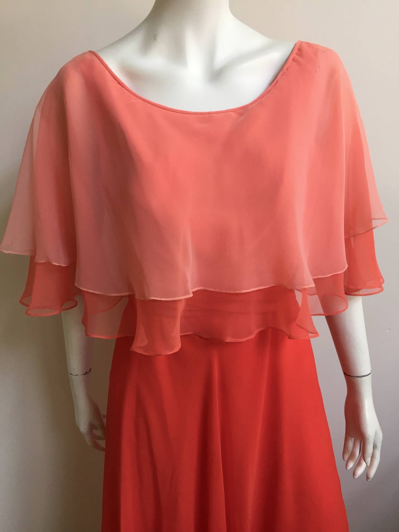 Mollie Parnis Boutique New York 1970s silk chiffon layered gown is a vintage size 14 but fits like a modern USA size 6.  Please see & use measurements to make certain this gown will fit you to perfection. Peach & orange layers of silk chiffon make