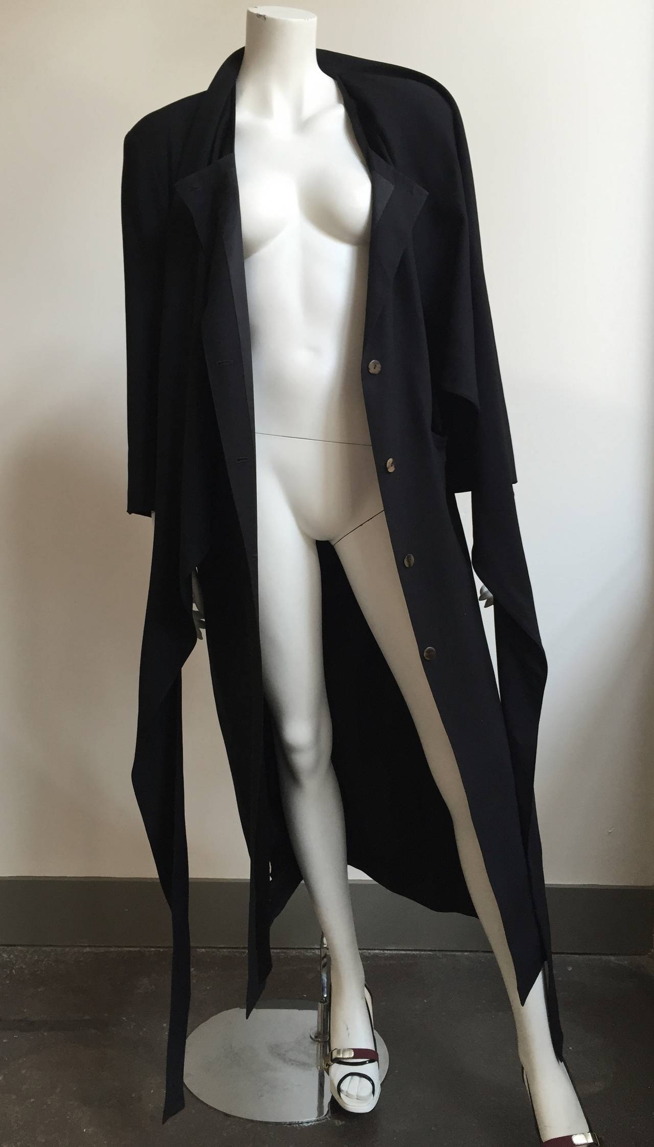 Jean Paul Gaultier 1980s long black wool button up coat is a size medium so it will fit a size 6/8 perfectly but please see & use measurements. The long tie scarf design makes for one stylish coat. Made of wool and made in Italy.
Measurements