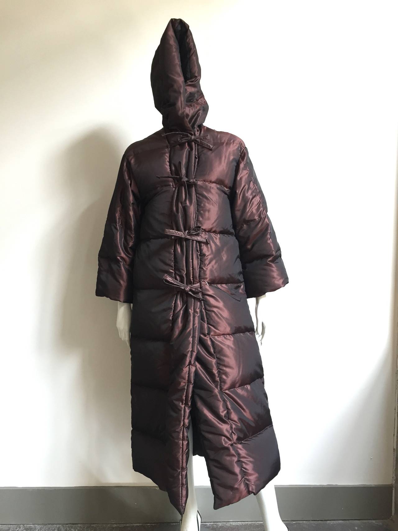 Bill Blass early 1980s metallic down coat with hood is a USA size 6.
Front zipper with 4 ties for that extra added Bill Blass touch. Down filled for that extra cold night. 
Measurements are:
21