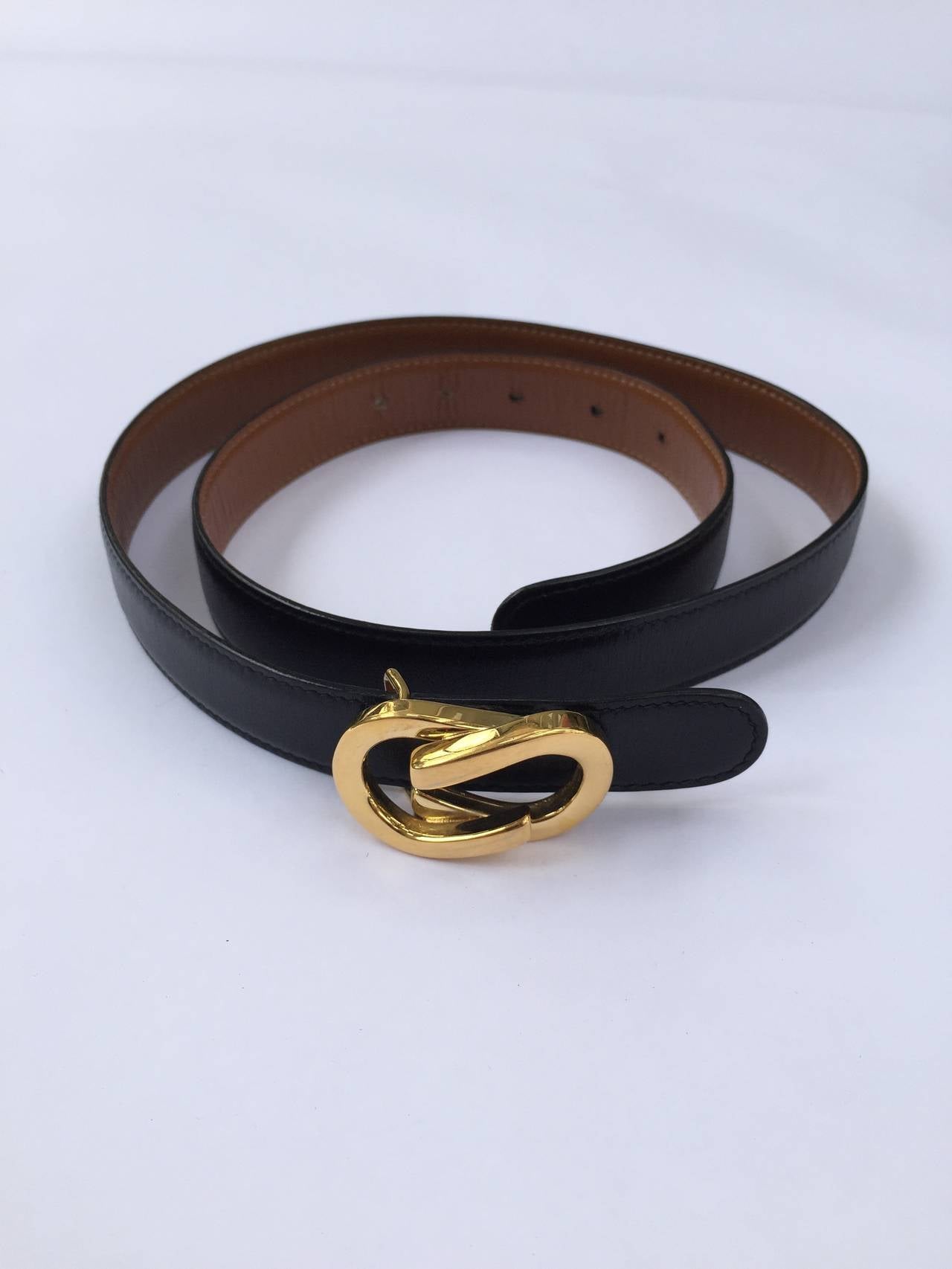 Gucci gold buckle on black leather strap made in Italy.
80-32
39
