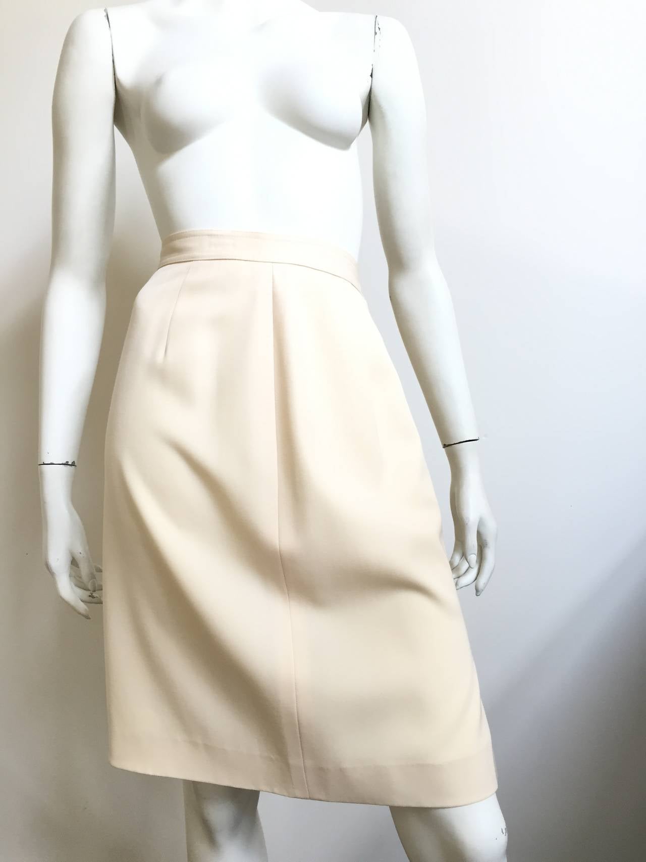 Valentino Miss V 1980s wool cream skirt is a vintage size 10 / 44 but fits like a modern USA size 6.   Please see & use the measures provided to properly measure your lovely body because we want to make Valentino proud. Skirt is lined. There are