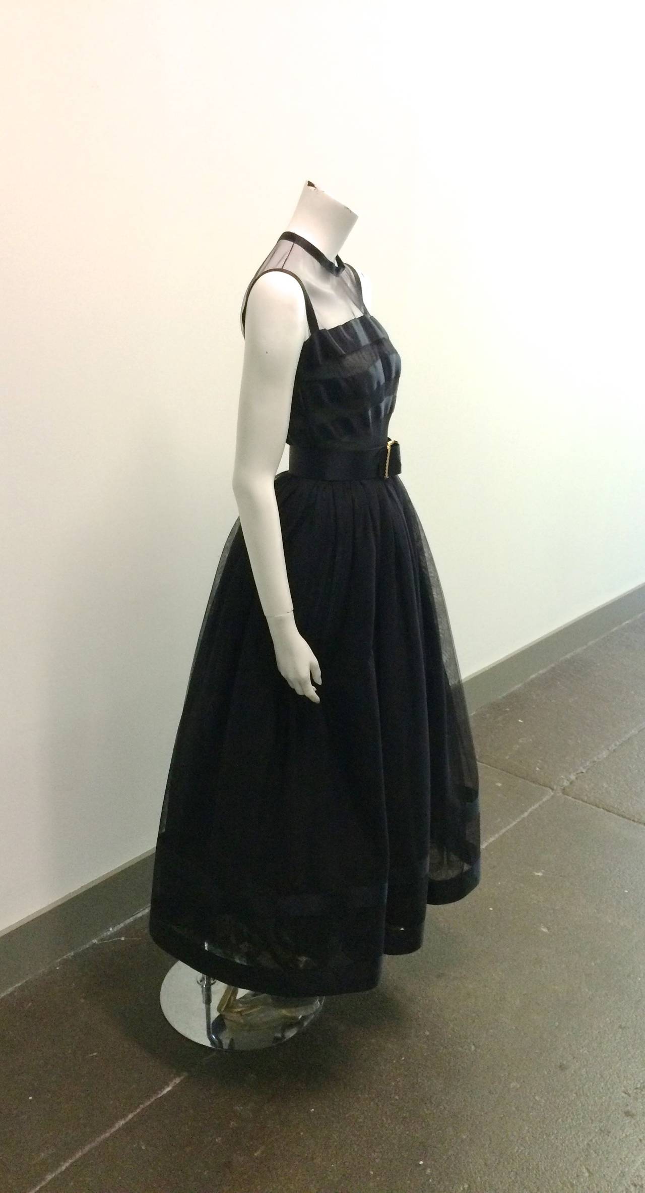 Chanel black ball gown size 34 purchased in Atlanta at the Chanel boutique in 1985 to wear to a Russian Ball at the Plaza Hotel in New York City. Black silk with layered tulle fabric.  Dress size is 34 and belt size is 36. Belt is 24.5