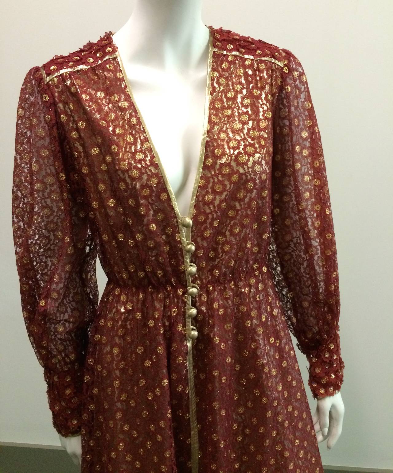 This gorgeous Norman Hartnell 1960s rust color lace with gold lame lining gown with elastic waistband is a show stopper. Gold lame buttons in front of gown as well as on cuff. Original size is 12 but fits 6 in today but please see measurements.