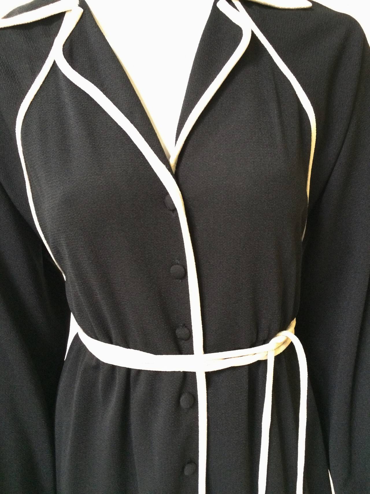Donald Brooks 1970s black with white trim fabric cover buttons dress with belt.  Dress size labels is 8 but fits the mannequin nicely which is a size 4. Ladies please grab your best friend, Mr. Tape Measure, so you can properly measure your bust,