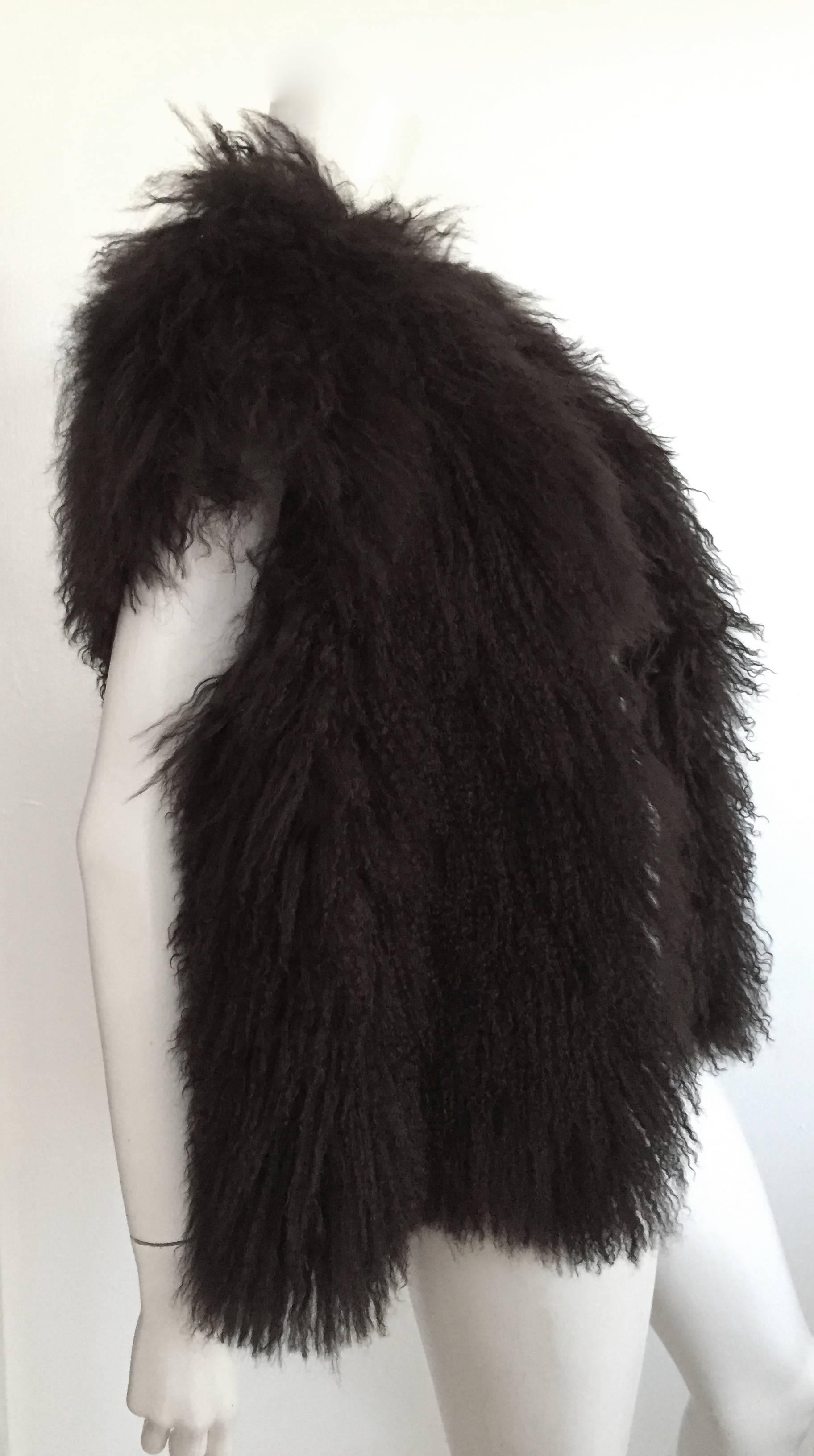 Sonia Rykiel Mongolian fun fur vest fits this size 4 mannequin perfectly but will also fit a size 6 / 8 as well but please see & use the measurements below so that you may properly measure your lovely body. This fur vest is timeless and goes with