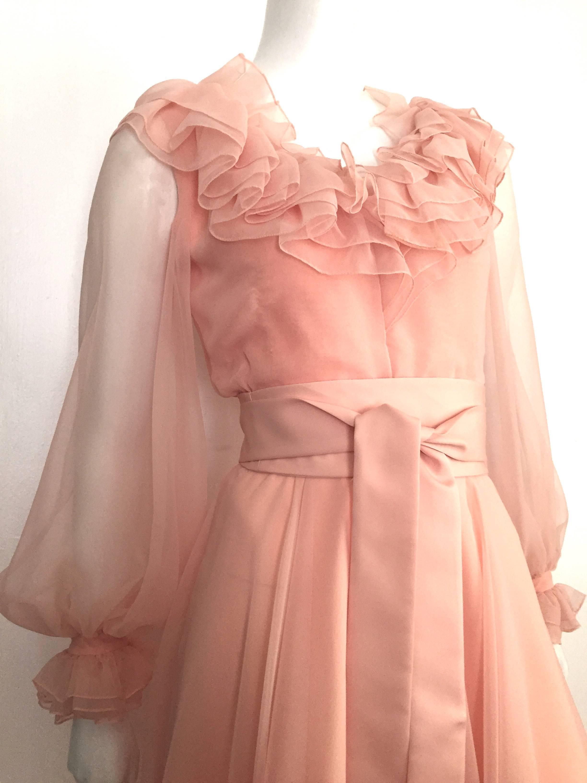 Luis Estevez 1970s peach chiffon layered cocktail dress is a size 4.  Please see & use the measurements below so you can properly measure your lovely body.
Layered ruffled collar and sheer ballooning sleeves adds that elegant touch to this timeless
