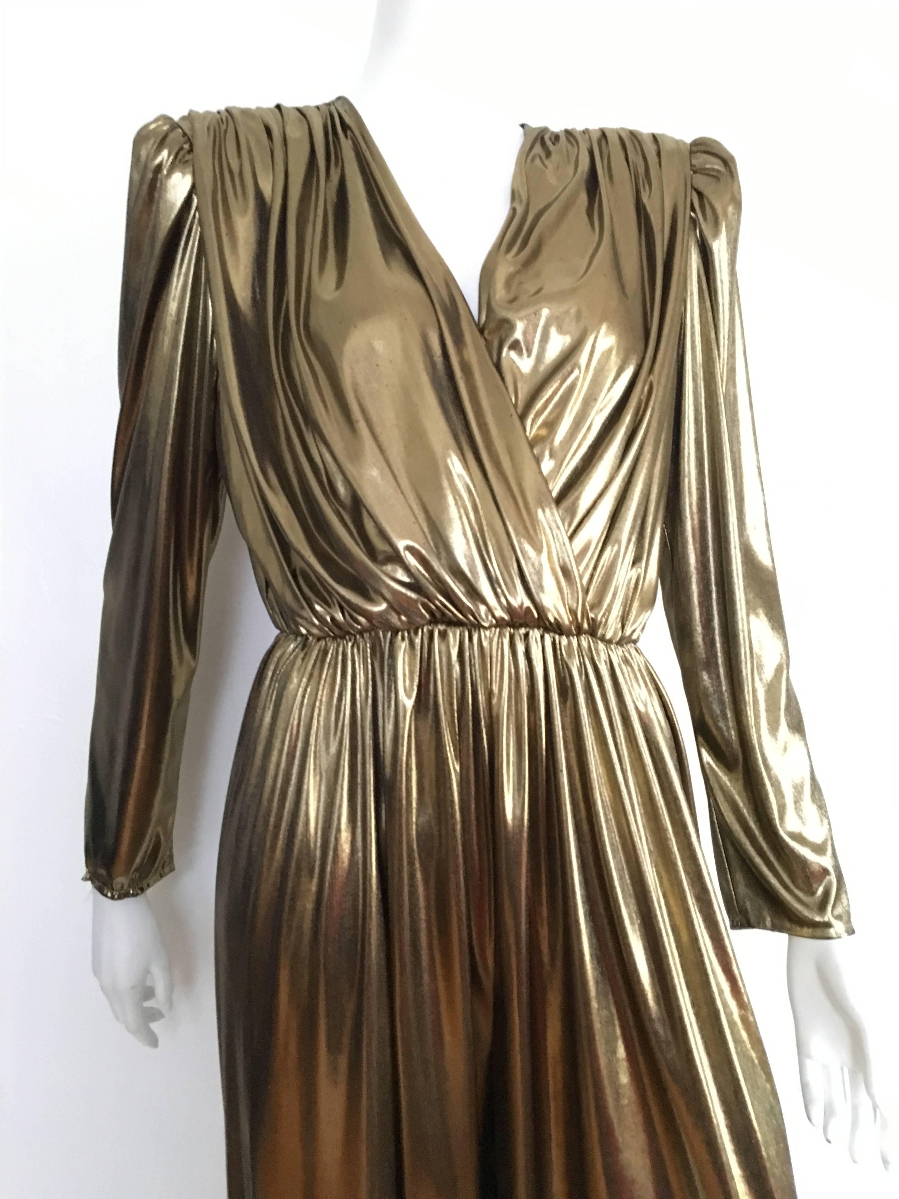 Gold 1980s lame jumpsuit by Filigree is a vintage size 10 but fits like a modern USA size 6.  Please see & use the measurements listed below so you can properly measure that lovely body. Criss cross top with bold shoulder pads and elastic waistband.