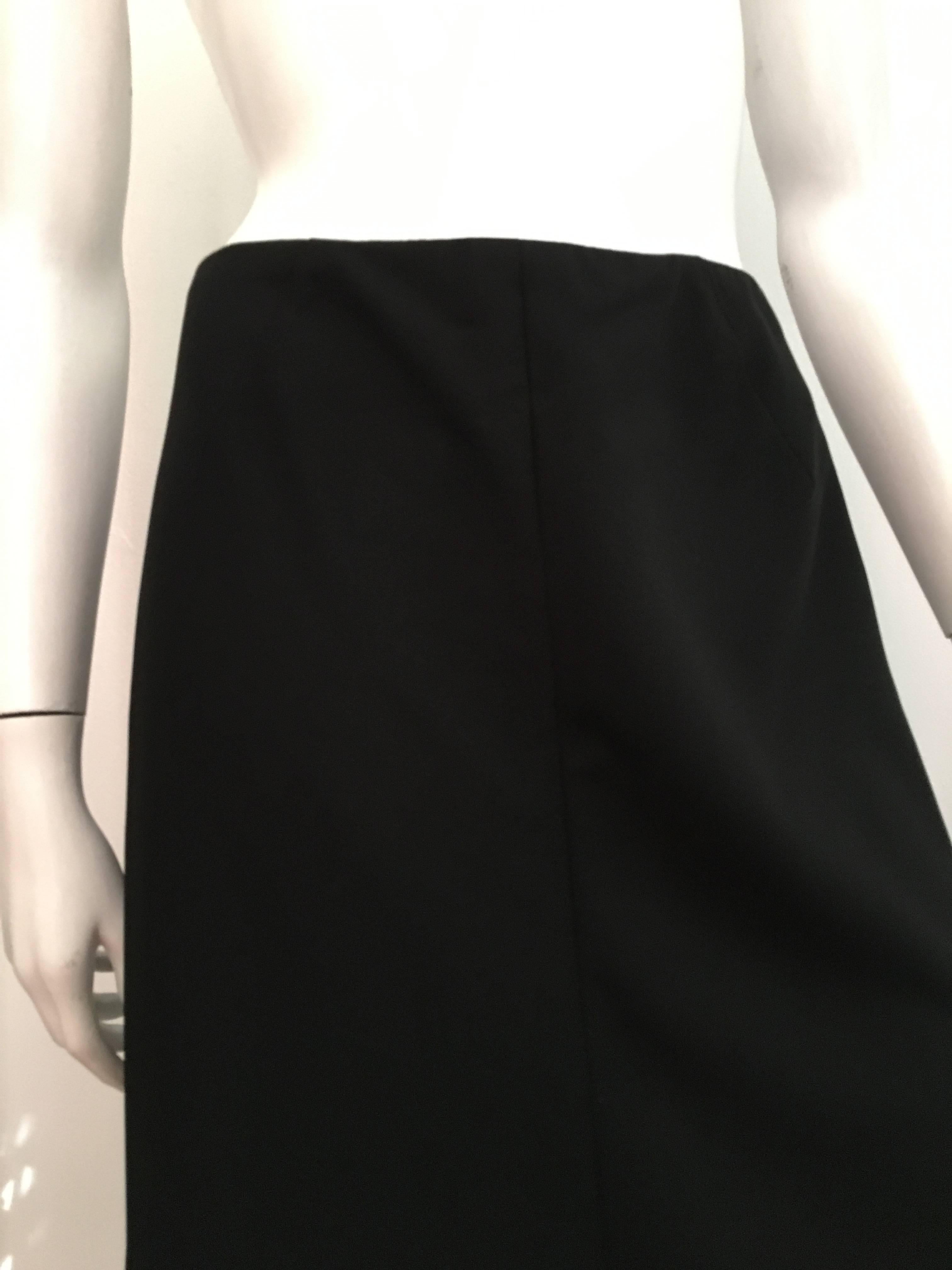 Chanel 1980s long black wool skirt is a vintage size 40 but fits like a modern USA size 6.  Please use your tape measure to properly measure your body so you know this will fit the way Coco wanted it to..  Skirt is not lined. Classic long skirt