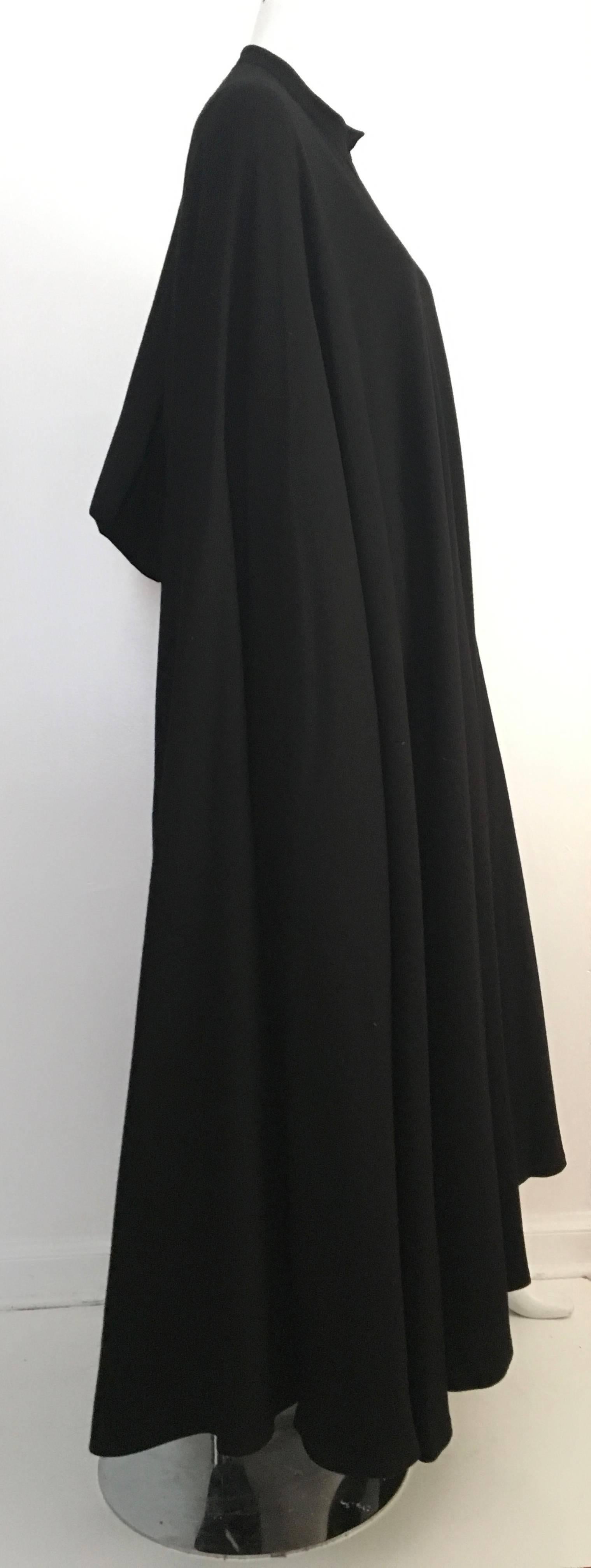 Guy Laroche 1970s black wool cape.  Capes are a MUST have for any woman's collection and what better cape than a vintage one? Capes never go out of style because the design is timeless. This is from the collection of a woman who in the 80s worked