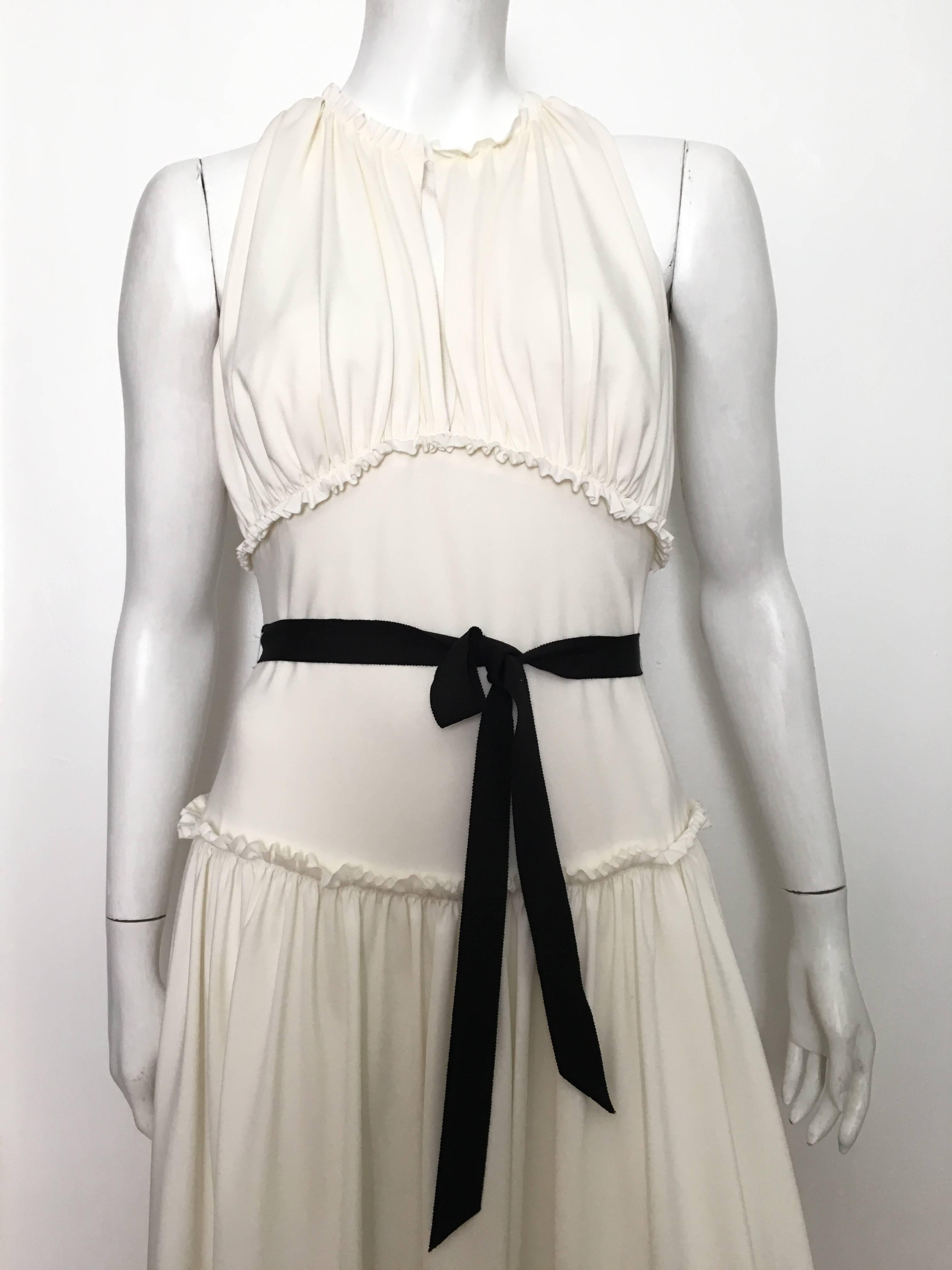 Vera Wang 1990s white jersey sleeveless dress with tie ribbon at waist is a size 10 / 44 but fits like a modern USA size 8.  Ladies please pull out your measuring tape so you can properly measure your bust, waist & hips to make certain this will