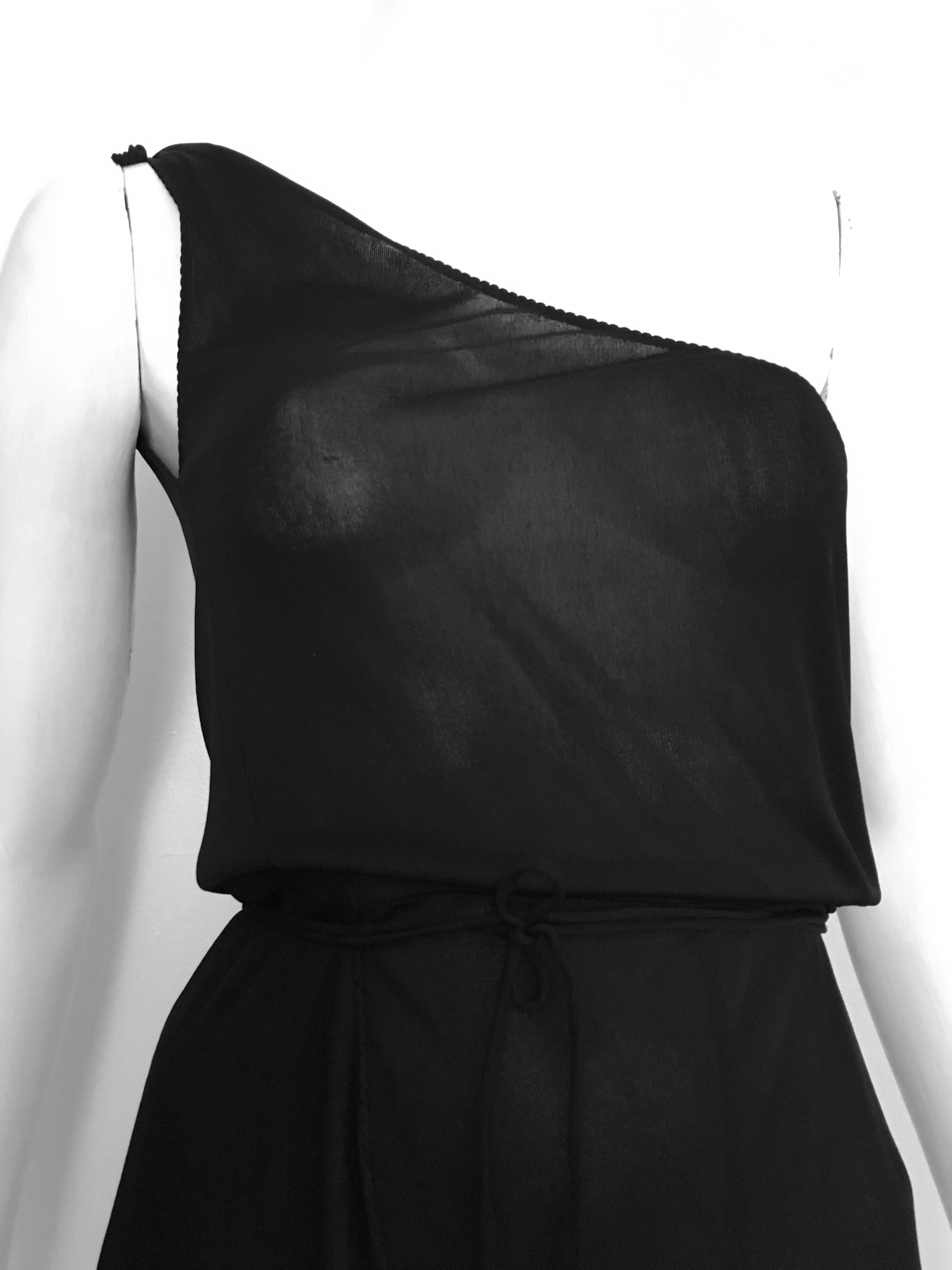 Stephen Burrows for Henri Bendel 1970s sheer black jersey one shoulder asymmetrical bottom dress is a size 4/6.  
If you have a body like this mannequin then it will fit you perfectly.  
Because this dress is sheer you will need to wear strapless