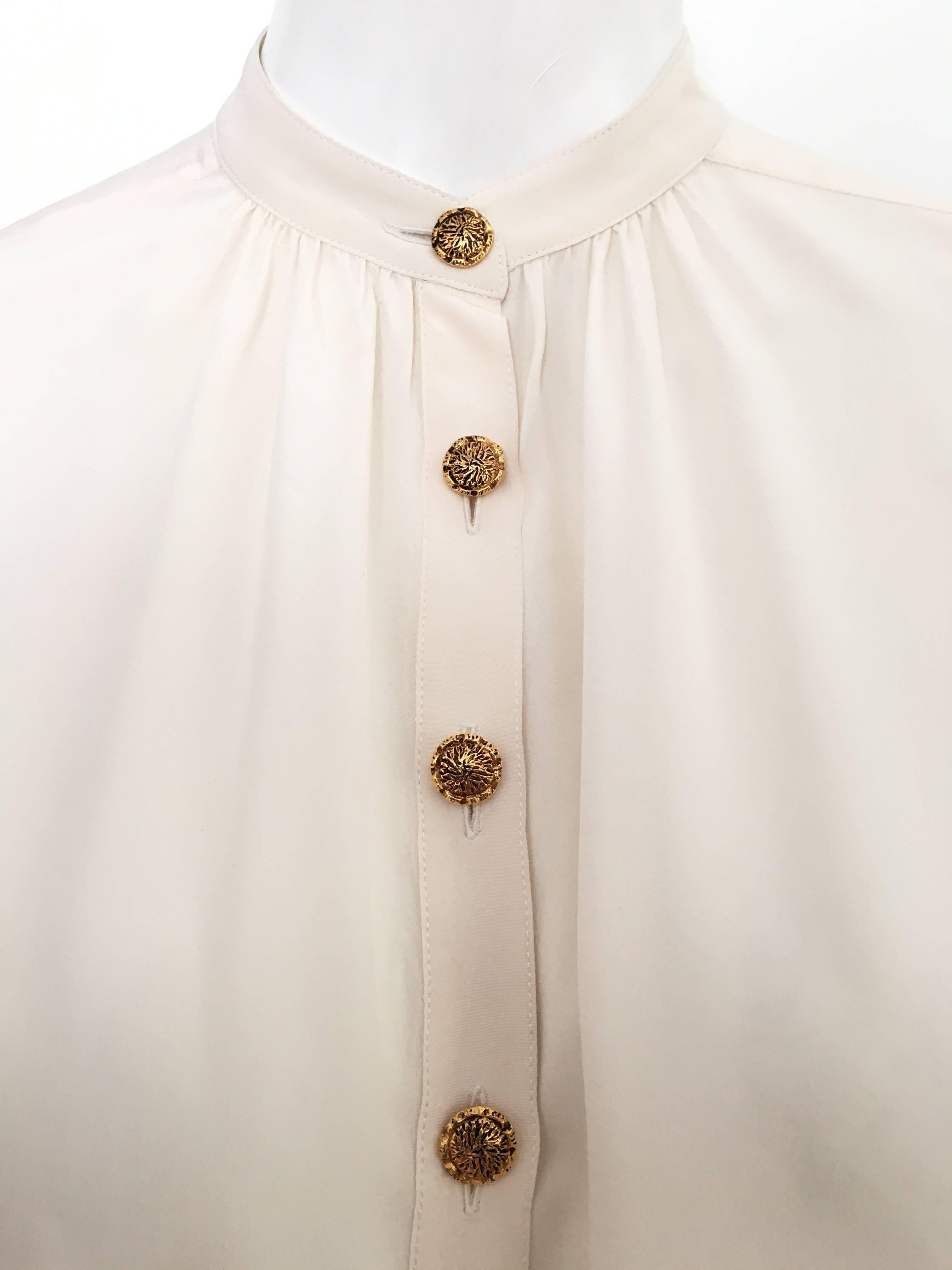 Yves Saint Laurent Rive Gauche 1990s cream silk loose fitting blouse is a French size 38 and will fit an USA size 6 perfectly.  This blouse is supposed to be oversized and loose.  Worn with your vintage Lanvin palazzo pants and off you go..... 