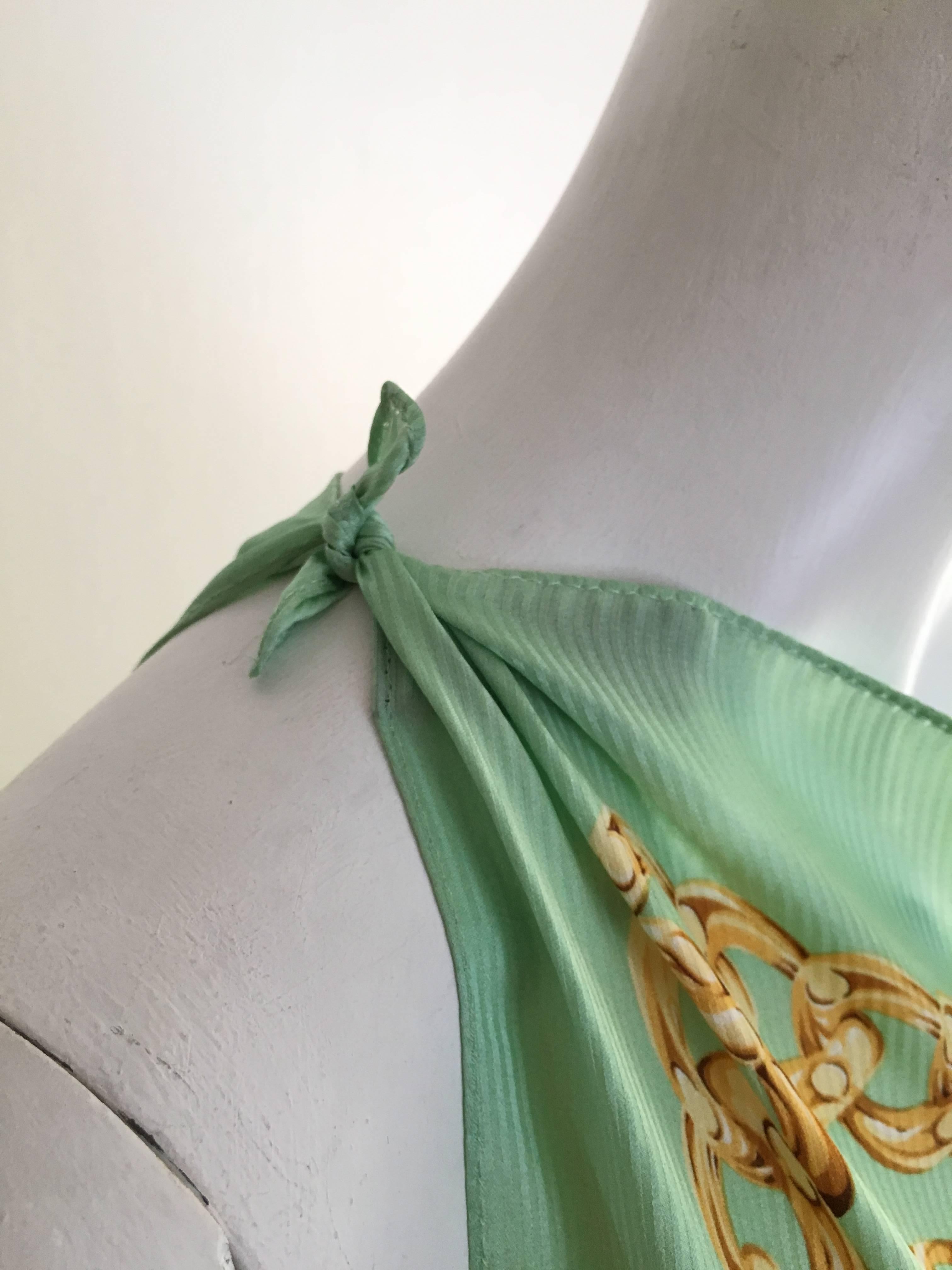 Paco Rabanne Paris 1997 celery green large silk scarf.
This gorgeous color and pattern is more than just your average scarf.  You can turn this into several different tops or even a cover up over a dress or your vintage YSL black slacks. Take your