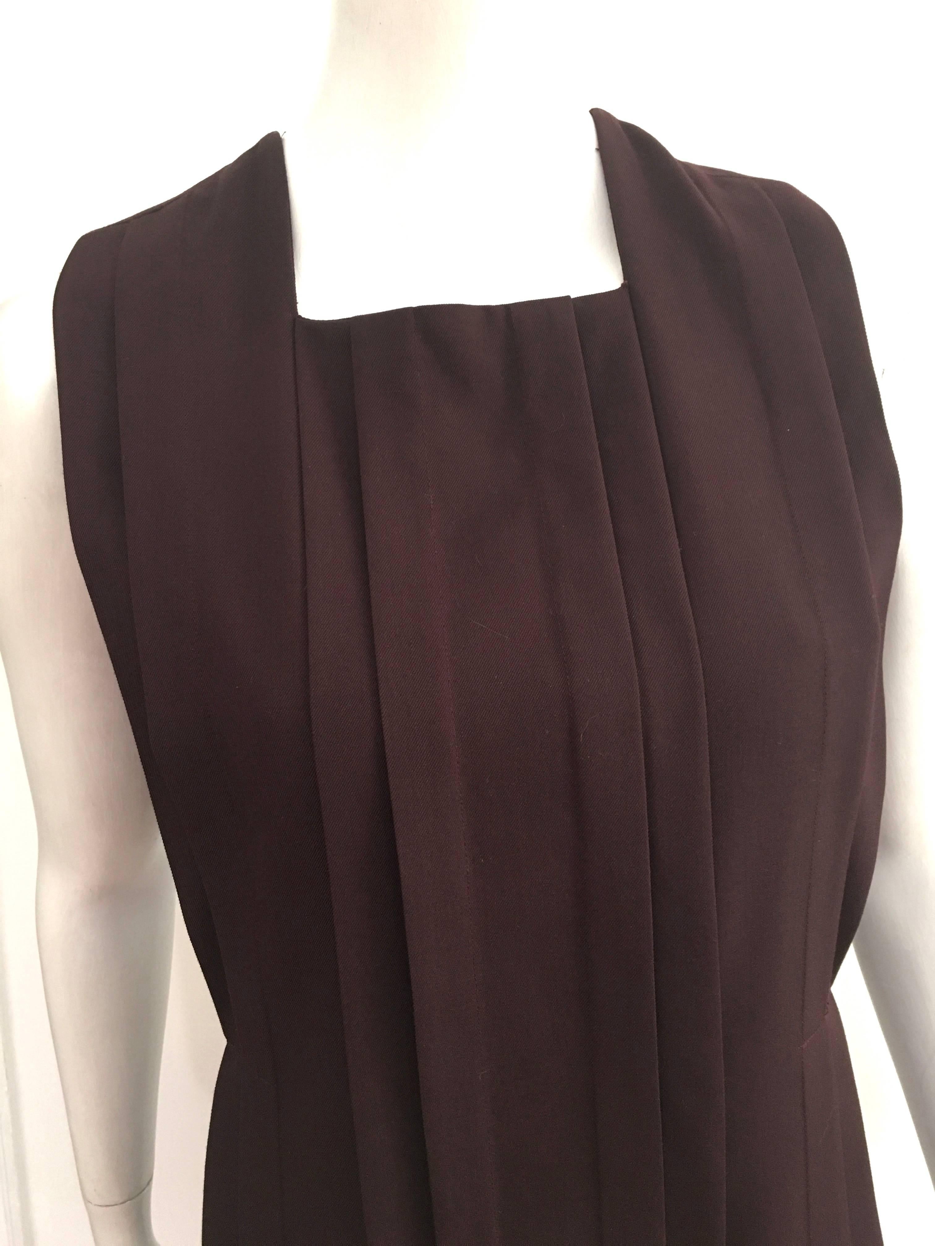 Cacharel burgundy wool sleeveless pleated dress is a size 8.  Ladies please use your measuring tape so you can properly measure your bust, waist & hips to make certain this will fit your lovely body. Pleats in front of dress as well as the backside