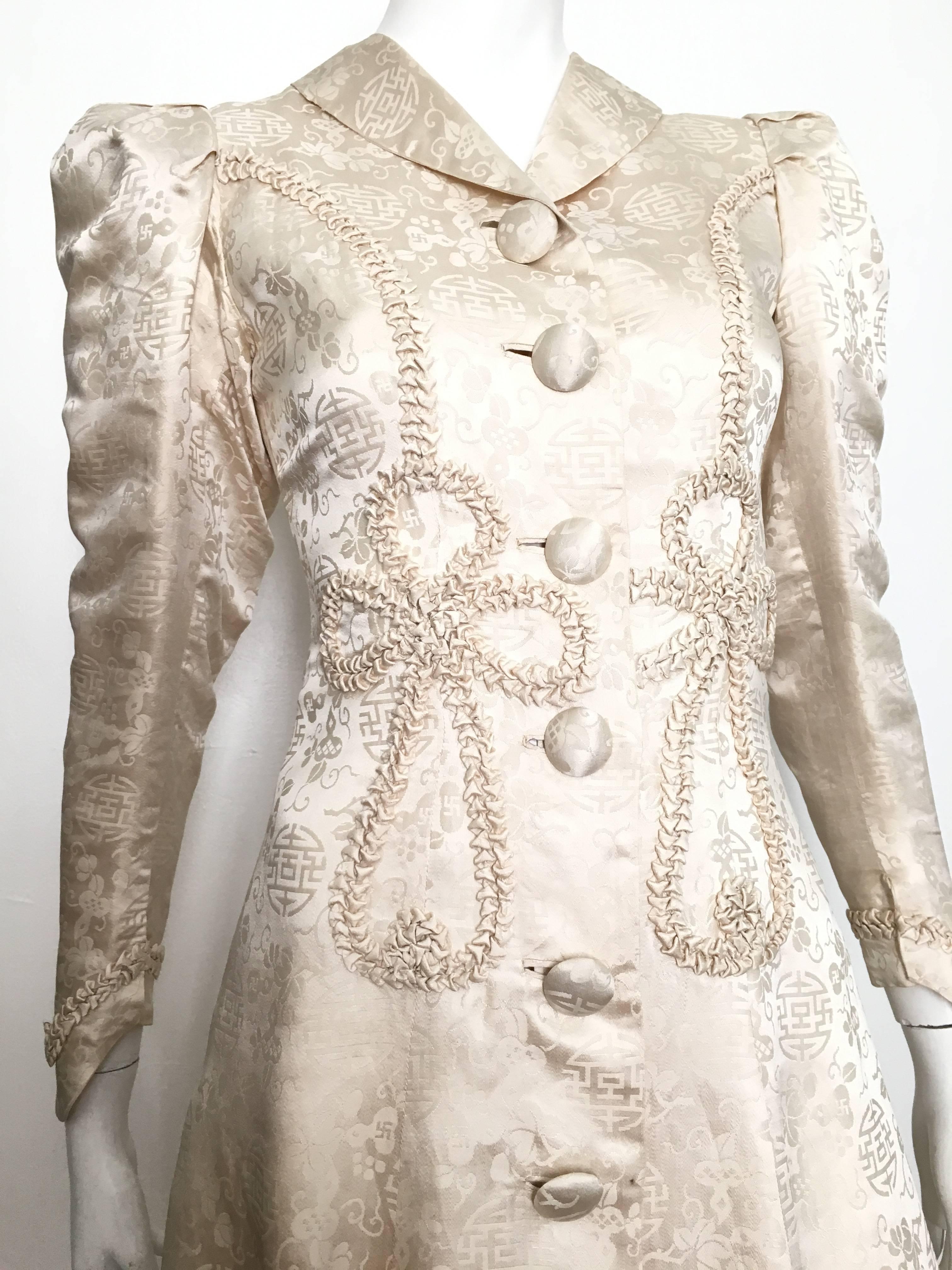 Gorgeous Asian early 1900s floor length silk opera coat is a size 4. 
This fits the size 4 mannequin perfectly with no wiggle room, so if your body is like this mannequin it will fit perfectly. 
The swastika pattern leads me to believe this might