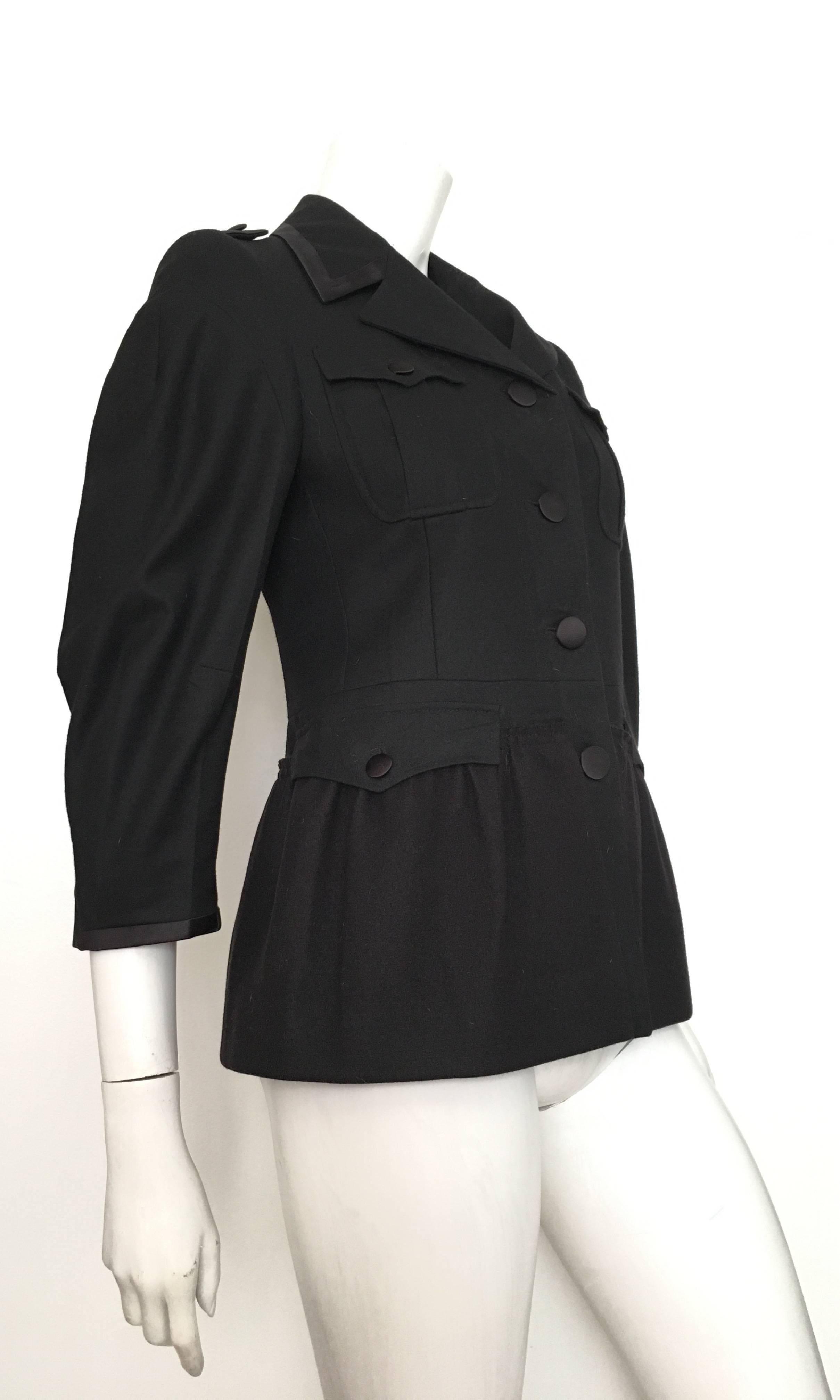 Miu Miu black wool with black silk trim peplum jacket is an Italian size 40 or an USA size 4.  Ladies please grab your trusted tape measure so you can measure your bust & arm length to make certain this will fit your lovely body. Four front