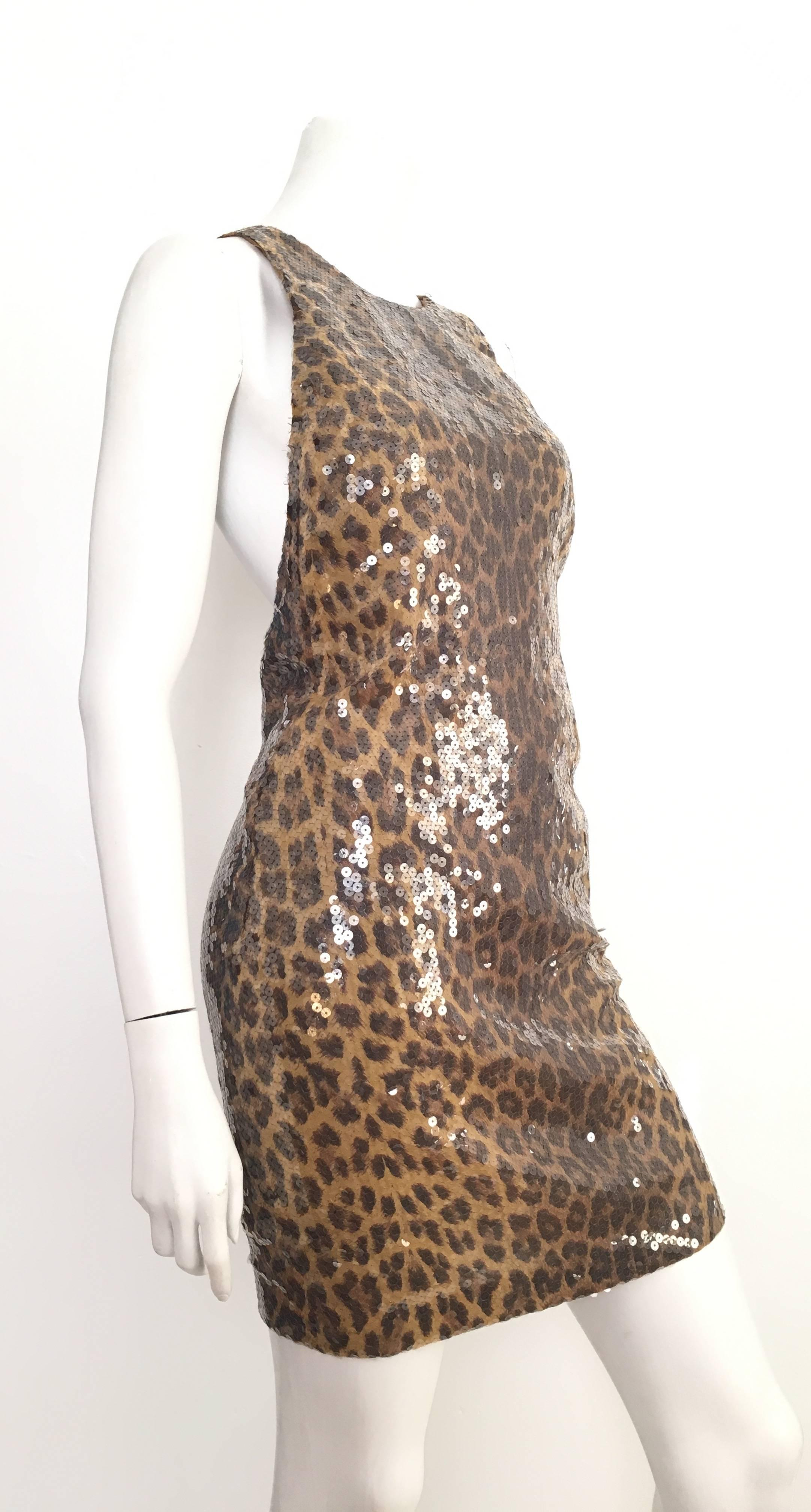 Vera Wang 1980s sequin cheetah print crisscross sexy cocktail dress is an USA size 6.  Ladies please grab your trusted tape measure so you can properly measure your bust, waist & hips to make certain this will fit your lovely body. From every angle