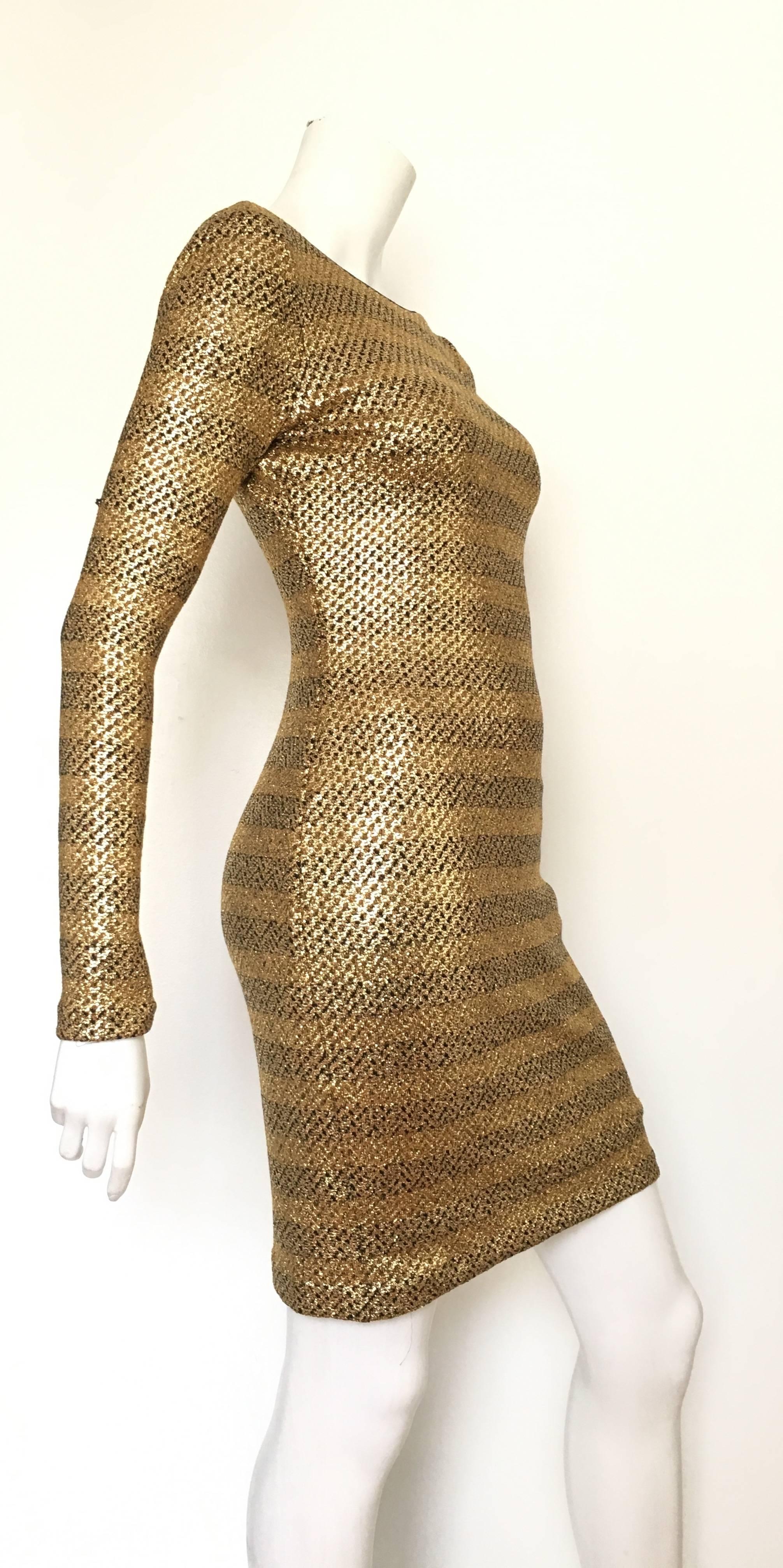 Badgley Mischka super sexy gold metallic stretch cocktail dress is an USA size 2 but also a size 4.  Matilda the Mannequin is a true size 4 and this dress fits her beautifully. Ladies please grab your trusted tape measure so you can measure your