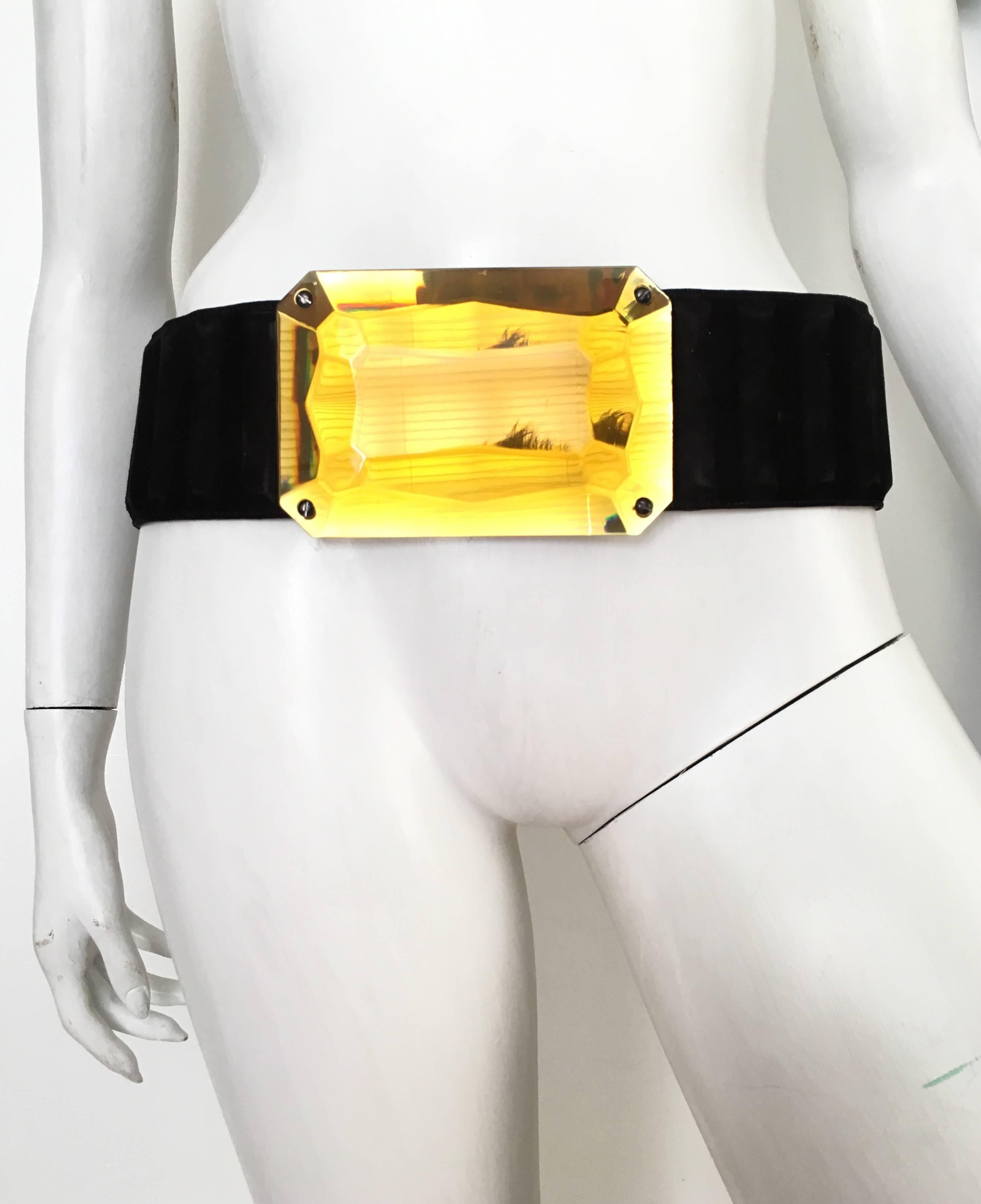 Fendi designed by Karl Lagerfeld emerald cut lucite chunky buckle with black suede belt strap is a size 34. There is a little stretch in the belt strap on the back side as shown in photo.  This eye POPing design will turn all the heads in your