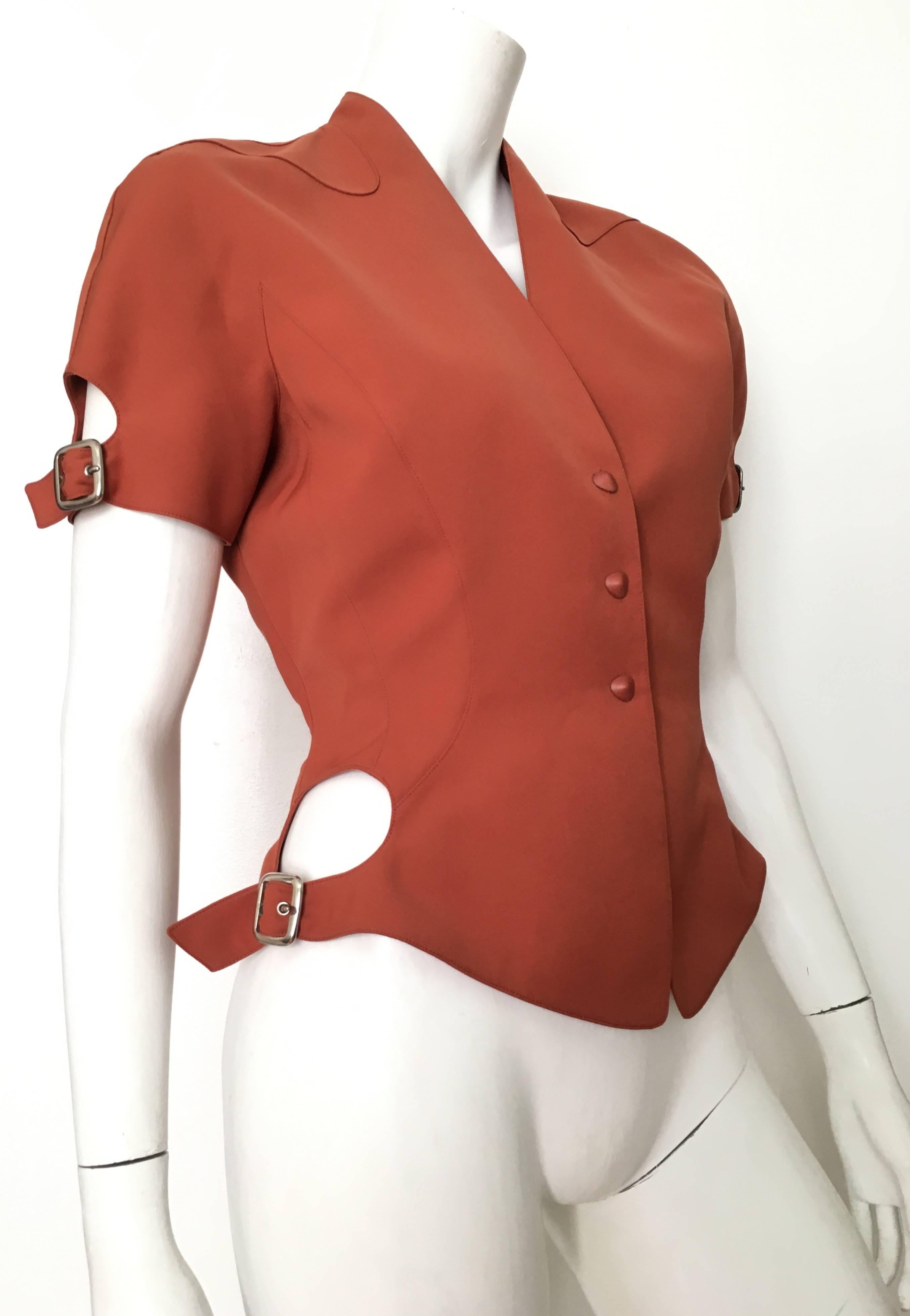 Thierry Mugler 1990s gorgeous rust color short sleeve jacket with adjustable buckles on the sleeves & waistline is a French size 38 and fits like an USA size 4.  Matilda the Mannequin is a size 4 and this jackets fits her perfectly.  Ladies