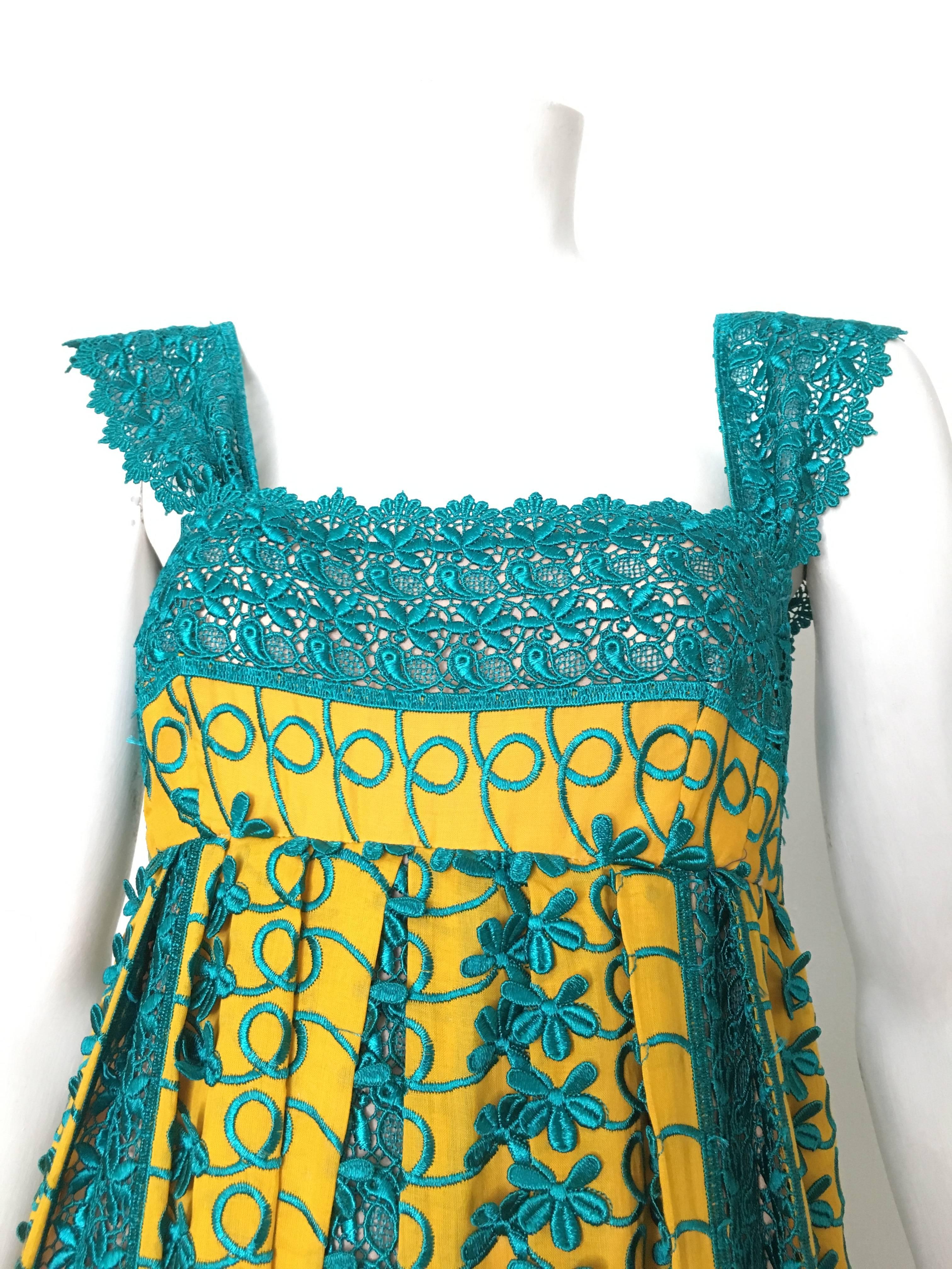 Tracy Feith turquoise / yellow lace & cotton sleeveless dress fits like an USA size 4.  Matilda the Mannequin is a size 4 and it fits her perfectly. Ladies please grab your tape measure and measure your bust, waist and hips to make certain this will
