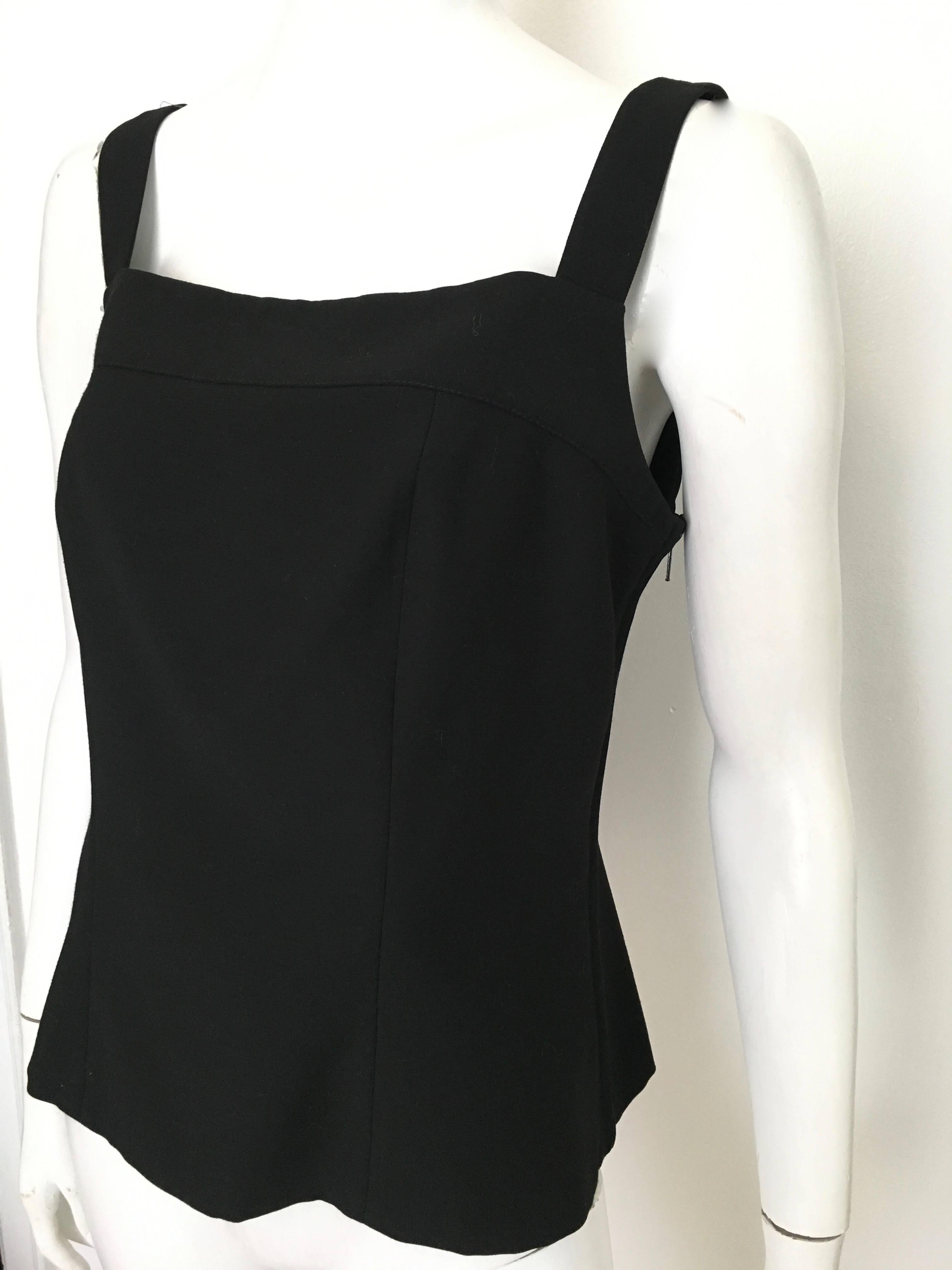 Yves Saint Laurent 1990s black wool camisole is a size 12.  Classic design and a must have for any woman's wardrobe.  Wear this YSL top with your Chanel pants and your Dior heels or with your favorite pair of denim jeans.  Either way you wear this