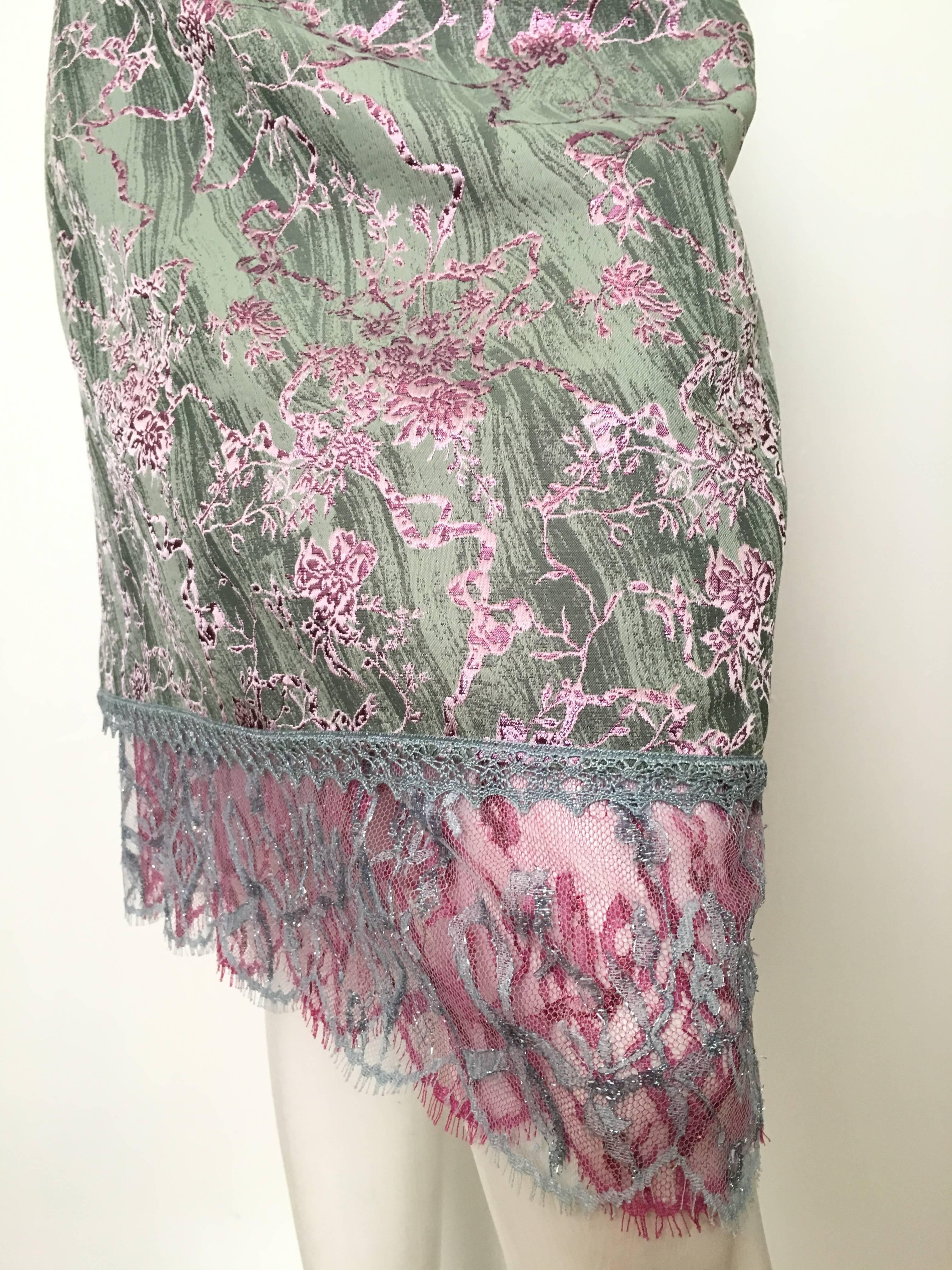 Christian Lacroix 1990s sea form color background with pink metallic floral print & lace trim skirt is a French size 40 and fits an USA size 8.  Ladies please grab your most trusted friend, Mr. Tape Measure, so you can properly measure your waist
