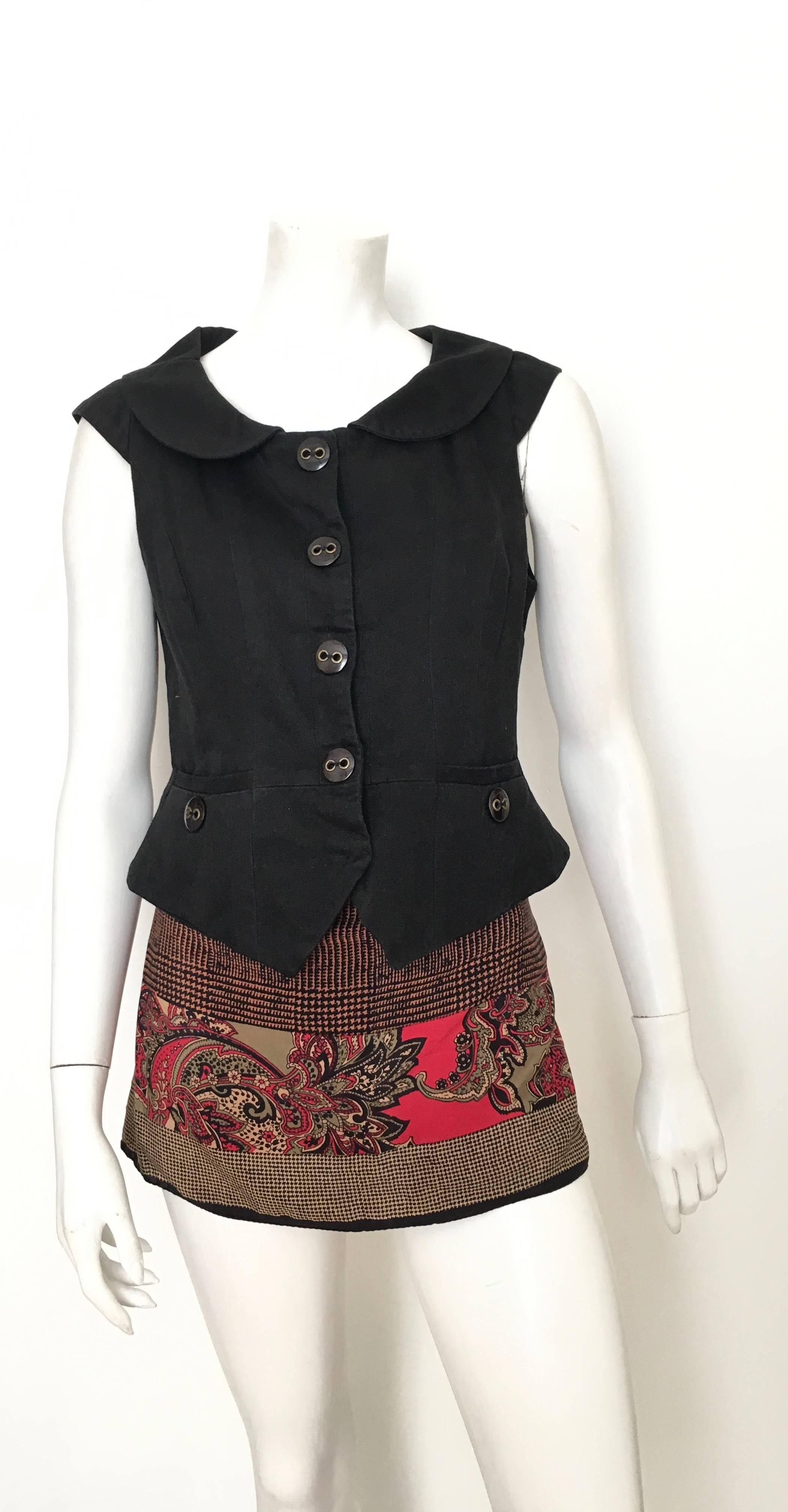 Marc Jacobs black snap button cotton vest with front pockets is an USA size 6.  Ladies please grab your trusted friend, Mr. Tape Measure, so you can properly measure your bust and waistline to make certain this piece will fit your lovely body. 