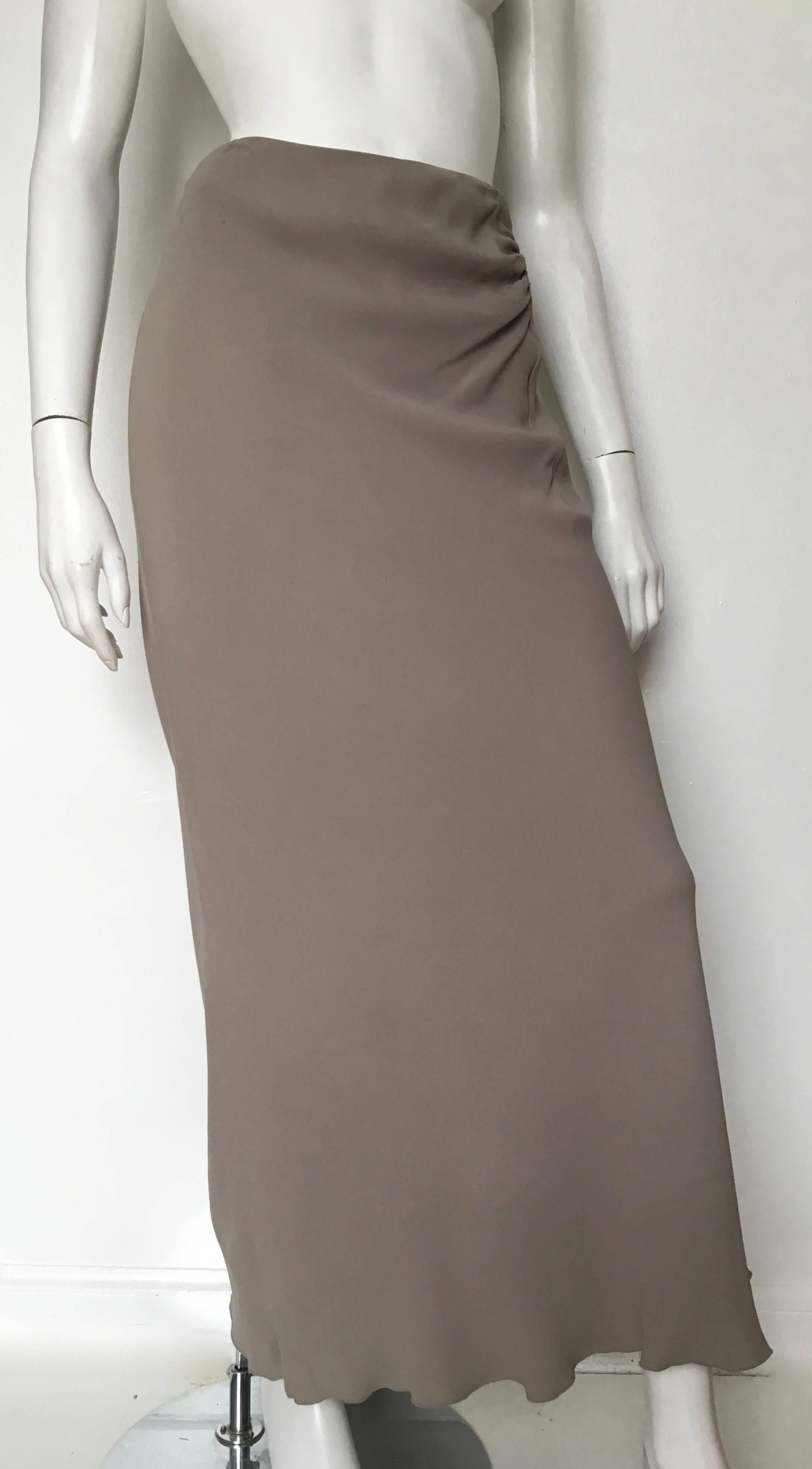 Guy Laroche 1990s grey silk long skirt is a French size 44 and fits like an USA size 10.  The skirt is labeled a size 12. Ladies please grab your tape measure so you can properly measure your waist & hips to make certain this will fit your