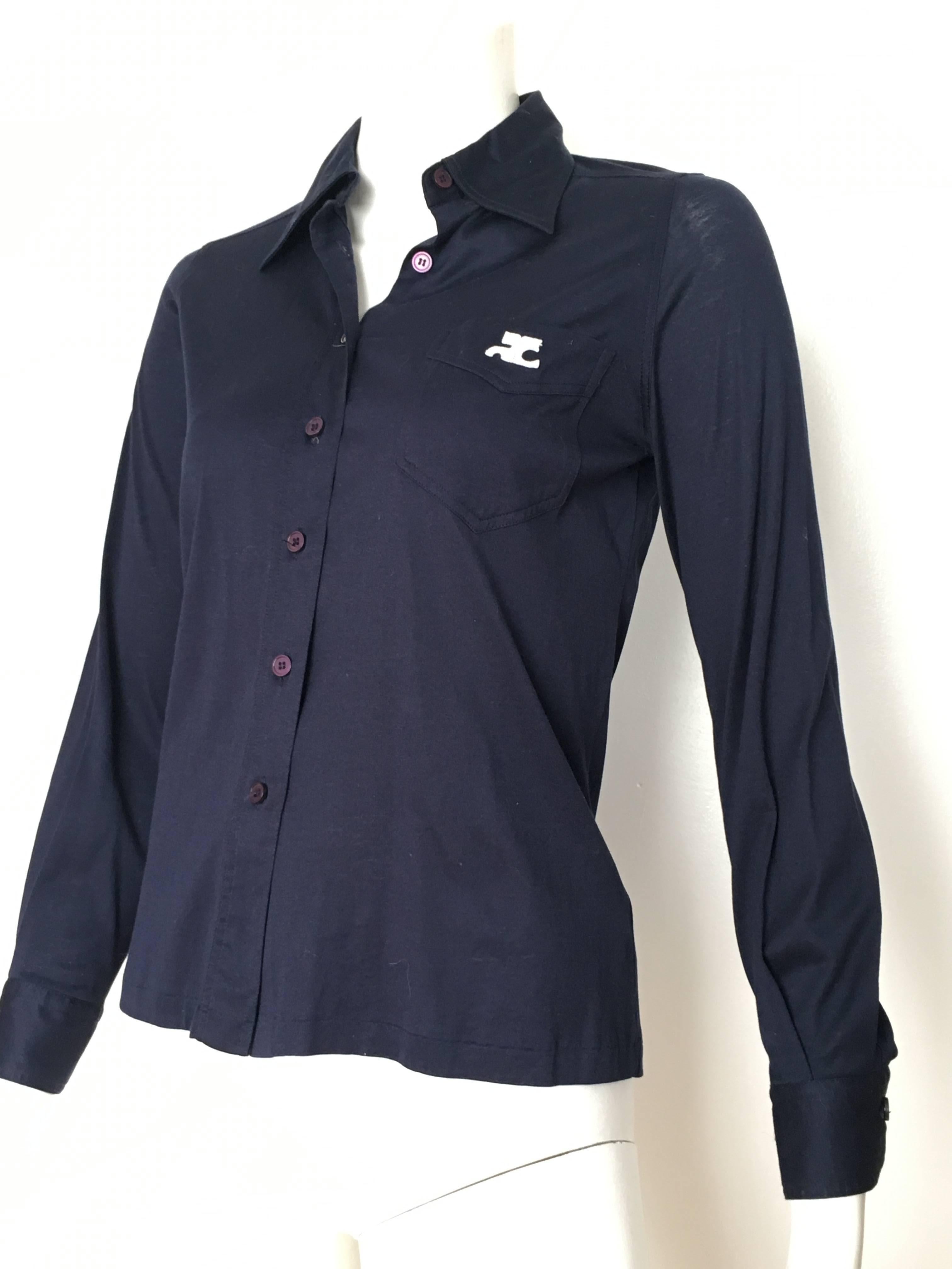 Courreges 1980s navy stretch cotton button up blouse is an USA size 4.  Iconic logo on front pocket.  Basic and classic this comfortable cotton Courreges blouse will keep hitting those home runs for you... Match this top with your vintage YSL skirt