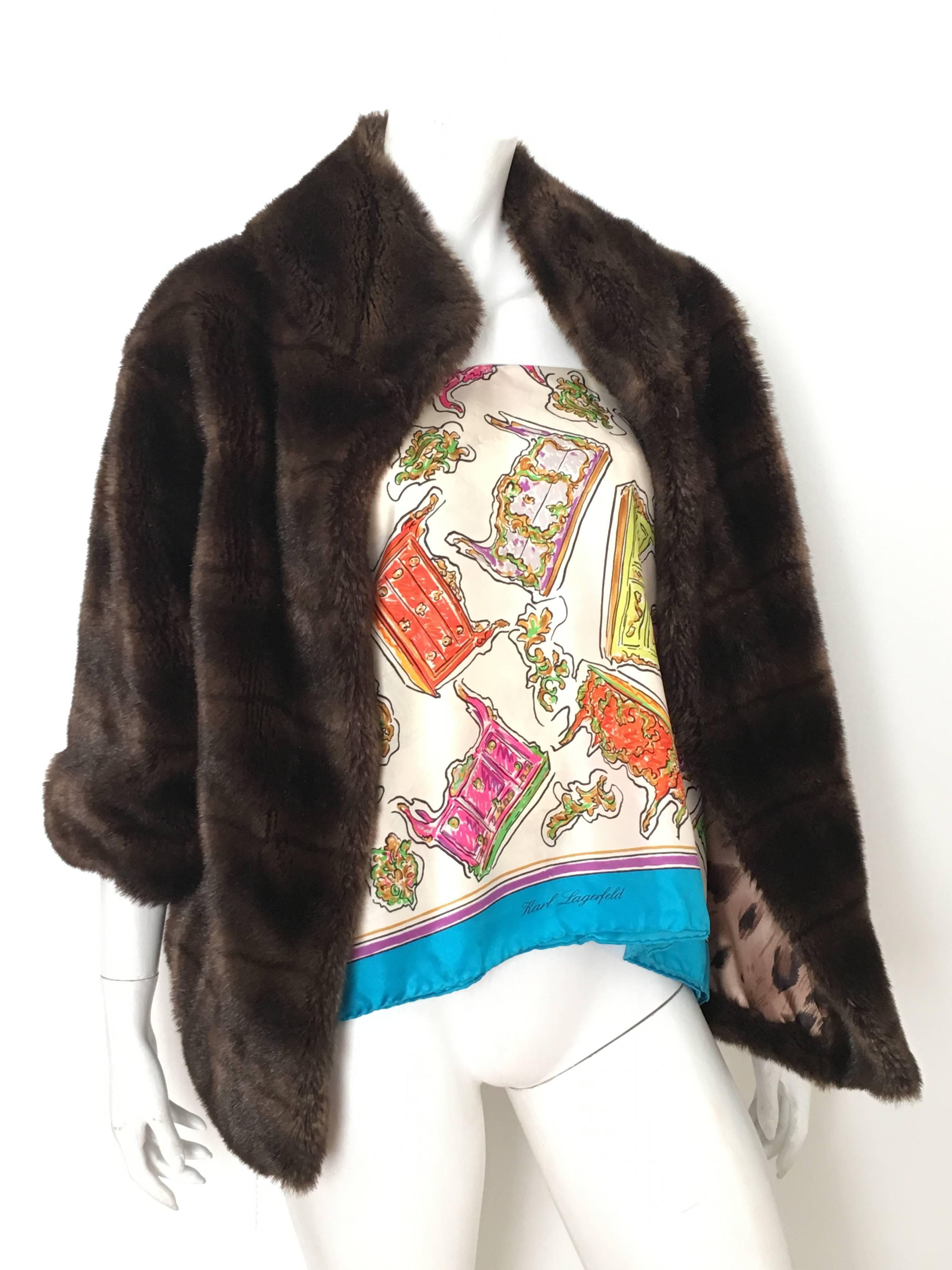 Sherry Cassin 1990s faux mink fur coat with pockets is a size small, which will fit a size 4/6. There are four hook and eye closures on front of coat. Why buy real fur when faux fur is so much better and no animals were harmed to design this piece.