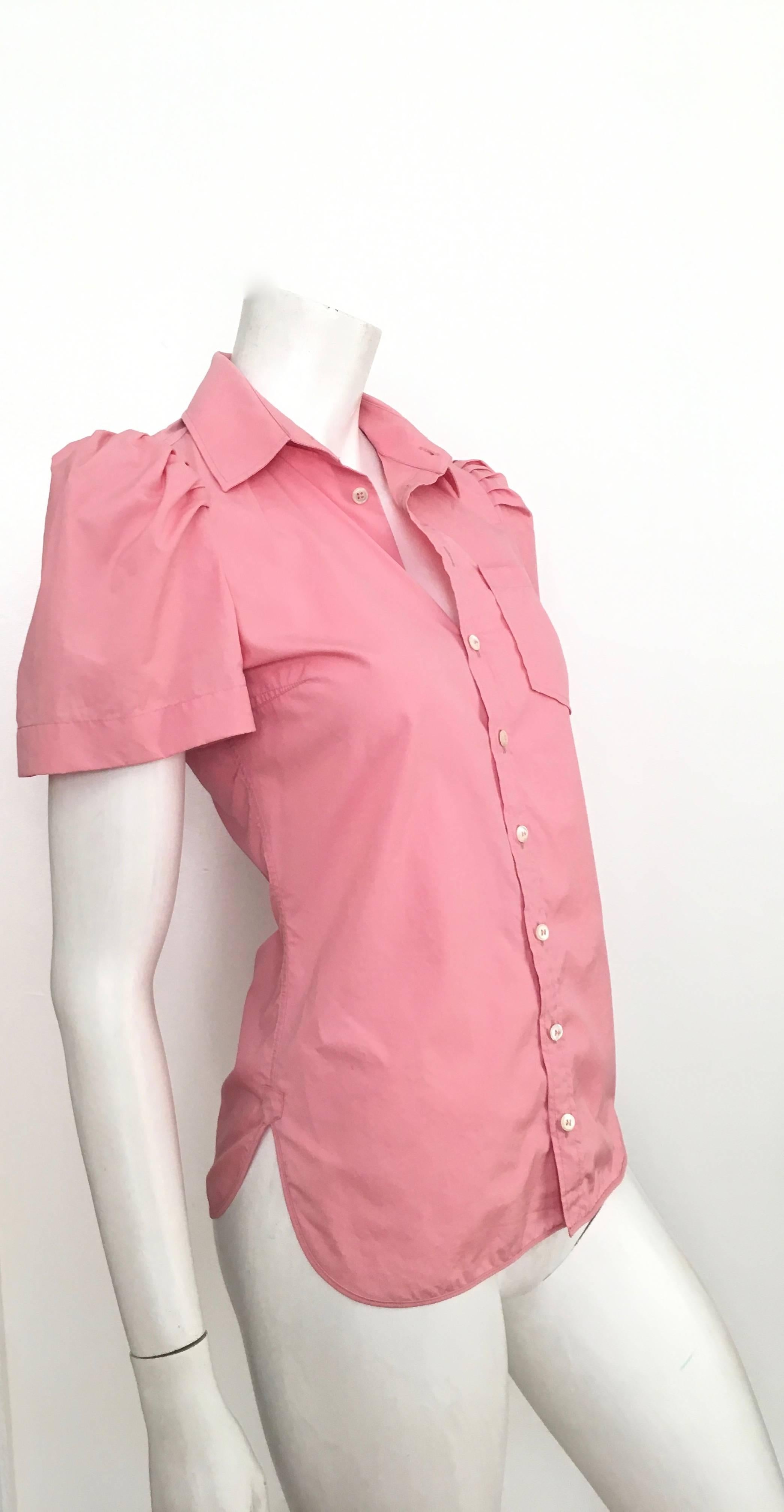 Balenciaga pink cotton poof short sleeve button up blouse is an USA size 4. This fits Matilda the Mannequin just perfectly, so if your body type is identical to Matilda then it's a win win.  
Measurements are:
34-1/2" bust 87cm
10" sleeves