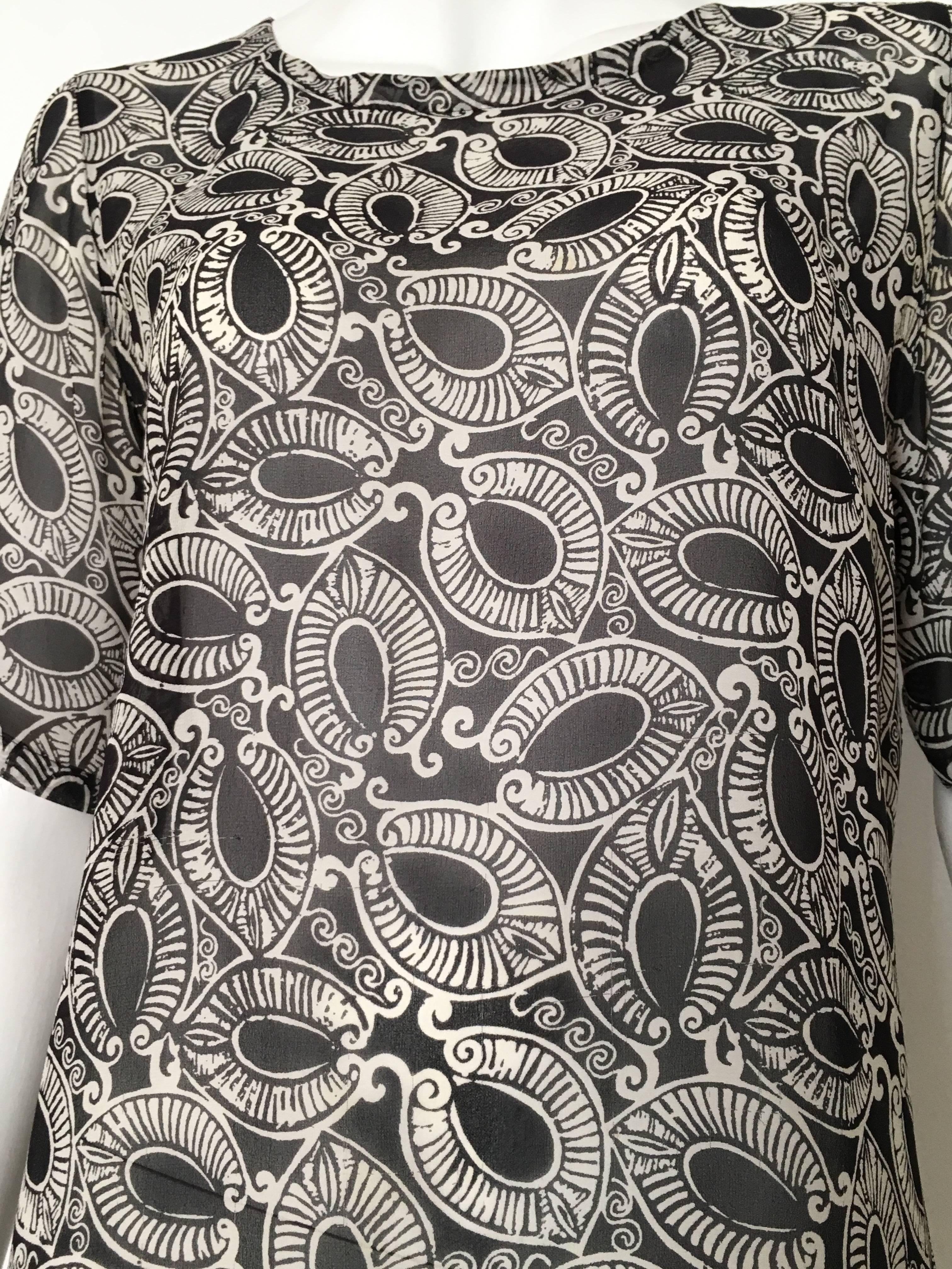 Valentino Miss V 1980s silk black & white print sheer blouse is a size 4 and an Italian size 38. There are 3 buttons on the back of neck and a replacement button inside blouse. Match this with your vintage Claude Montana pants and your Dior