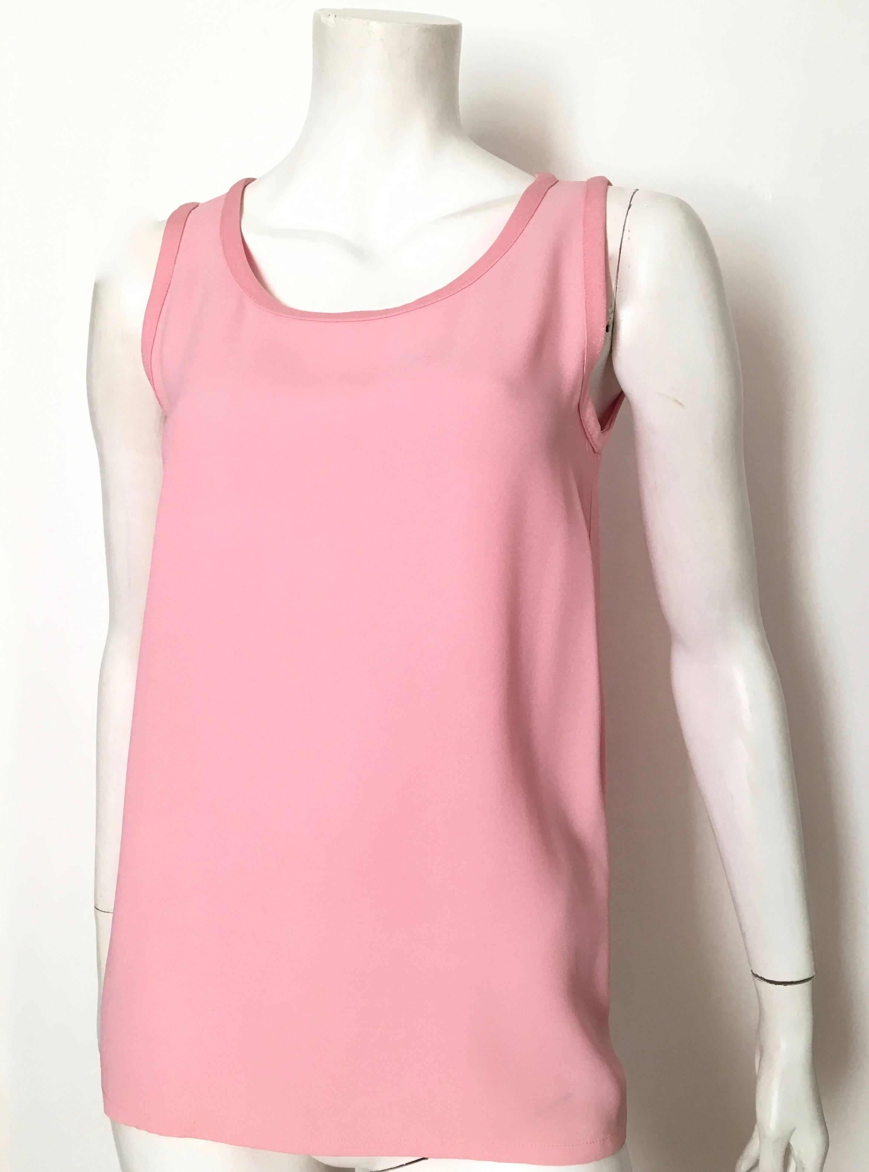 Saint Laurent Rive Gauche 1970s pink silk crepe sleeveless oversized blouse is a French size 38 and fits like an USA size 6. This blouse is supposed to be an oversized blouse, it's all about the flow of fabric. Match this with your vintage YSL