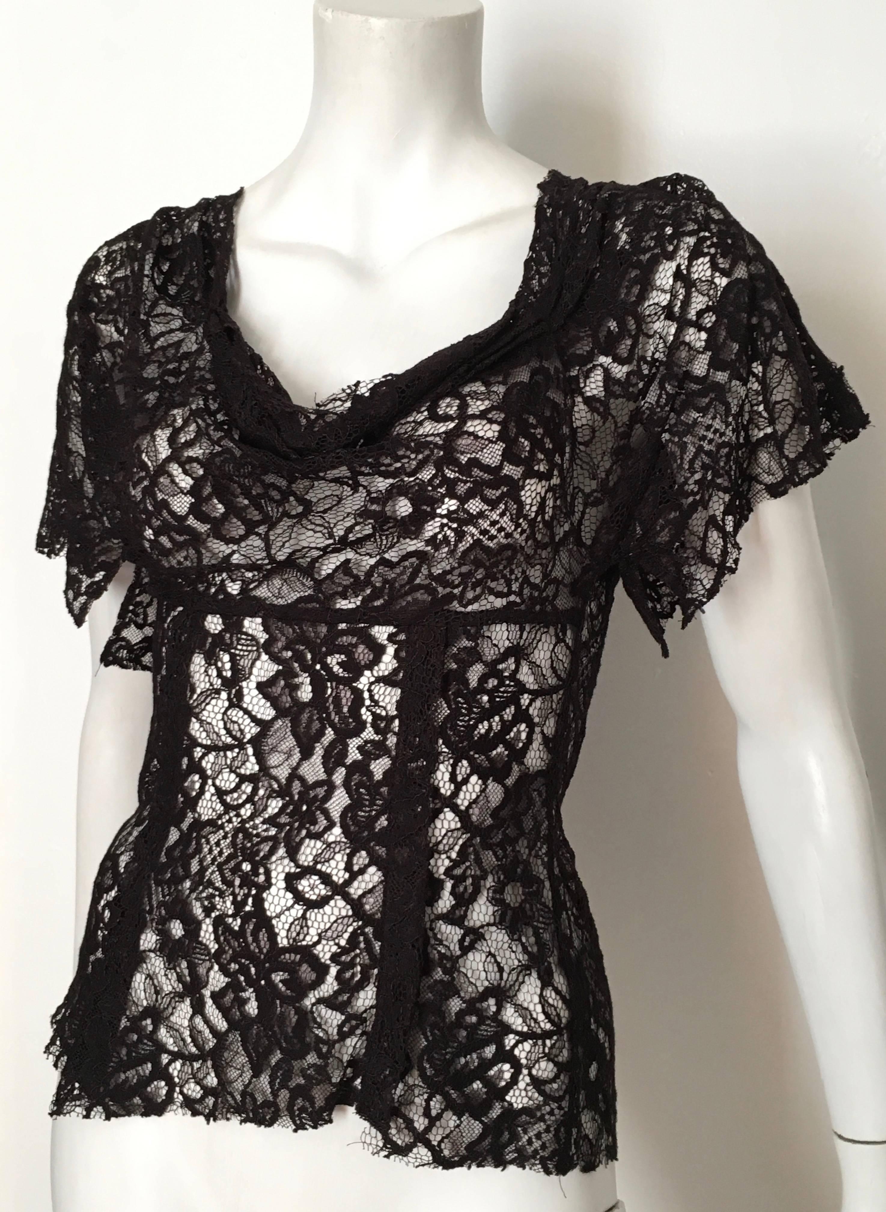 Alexander McQueen black lace top fits an USA size 4.
Sexy black lace top will look amazing with your vintage YSL black tuxedo pants or your Thierry Mugler skirt. Made in Italy.  Zipper in back of top. 
Measurements are:
29" bust 74cm
27"