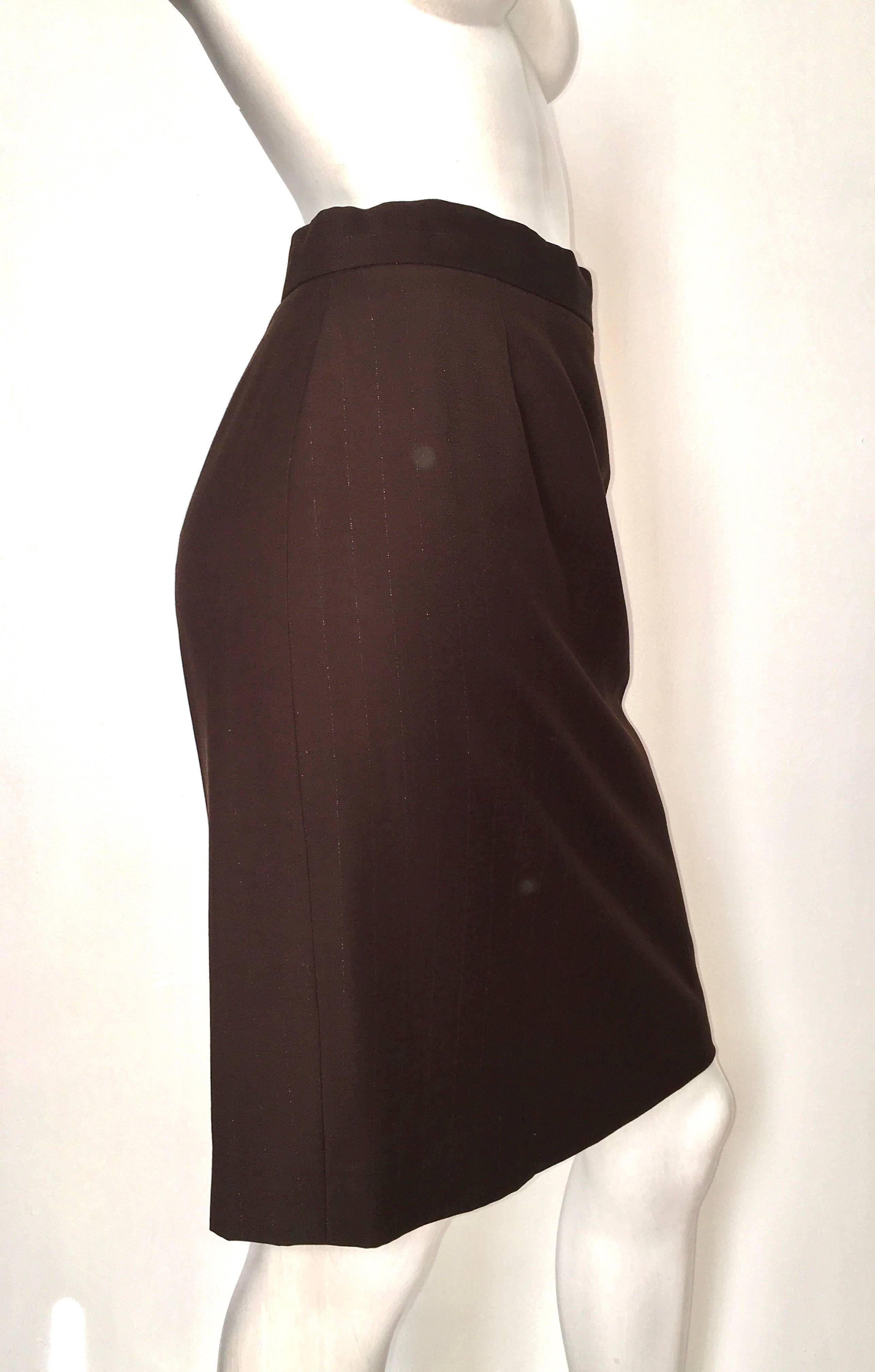 Givenchy Couture 1990s brown wool with very faint silver metallic pin strips is a French size 38 and will fit an USA size 4.  Ladies please grab your tape measure so you can properly measure your waist & hips to make certain this will fit your