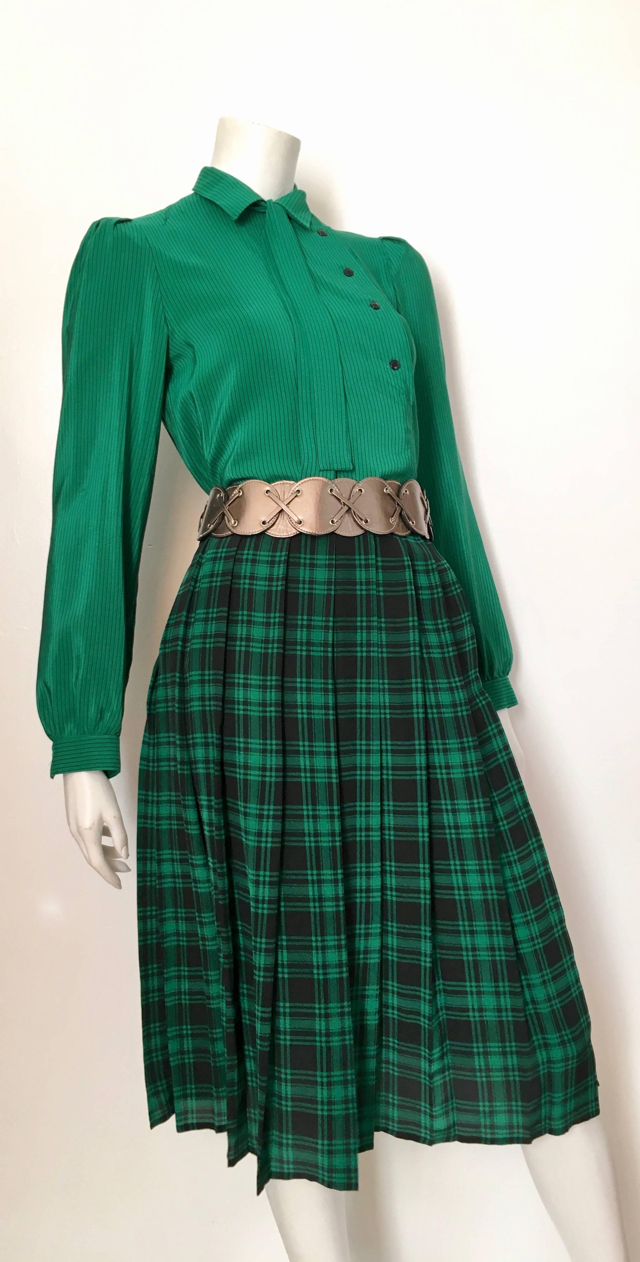 Oscar de la Renta Miss O 1980s green silk pin striped blouse with plaid pleated skirt is marked as a size 6 but fits like a modern size 4. Ladies please grab your tape measure so you can measure your bust, waist, hips, sleeves to make certain this